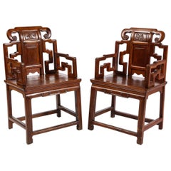 Antique Pair of Chinese Hardwood Chairs with Fretwork Designs and High Relief Panels