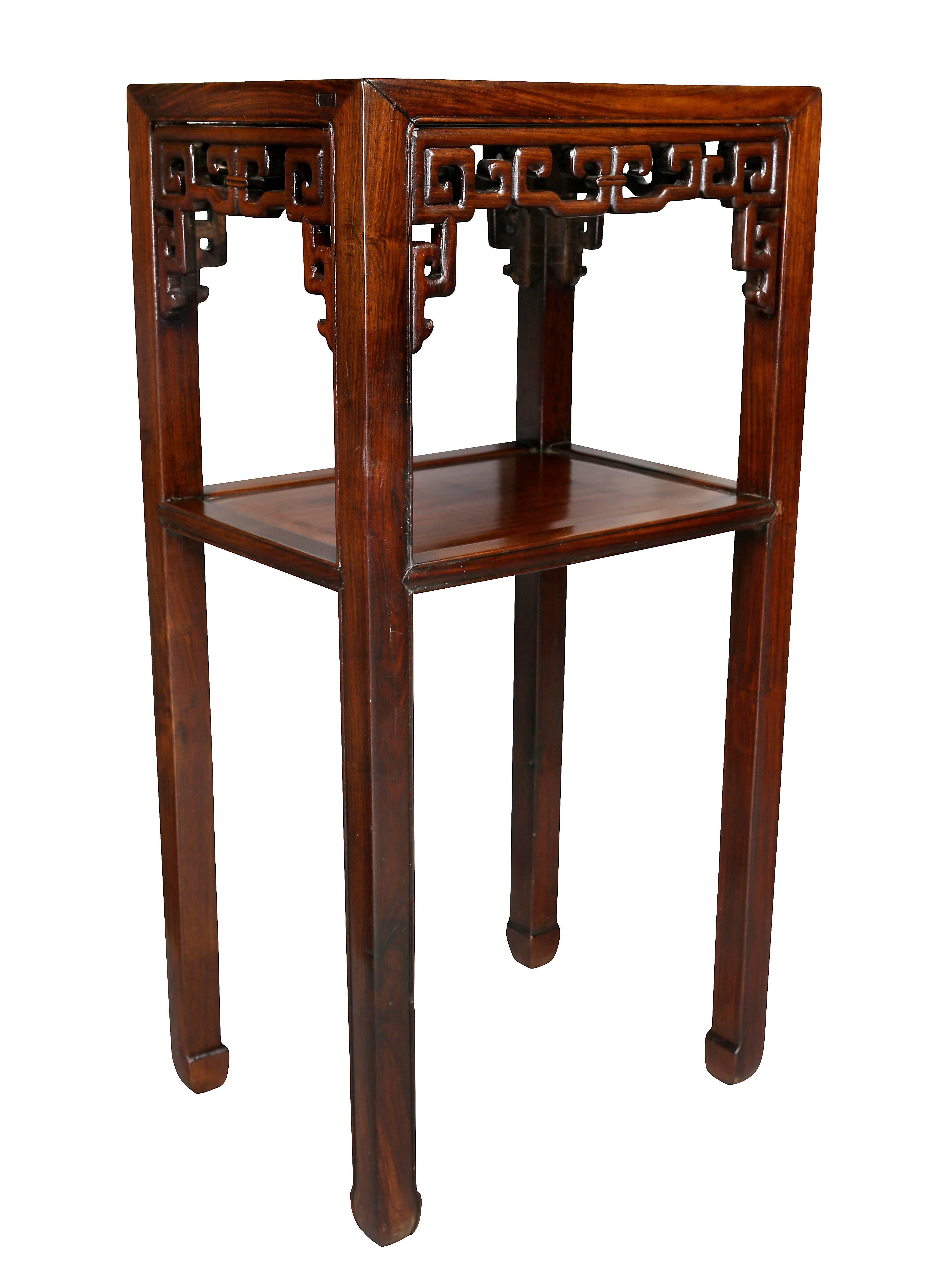 Each with a rectangular top over a carved openwork frieze with square section legs joined by a lower shelf, scrolled feet.