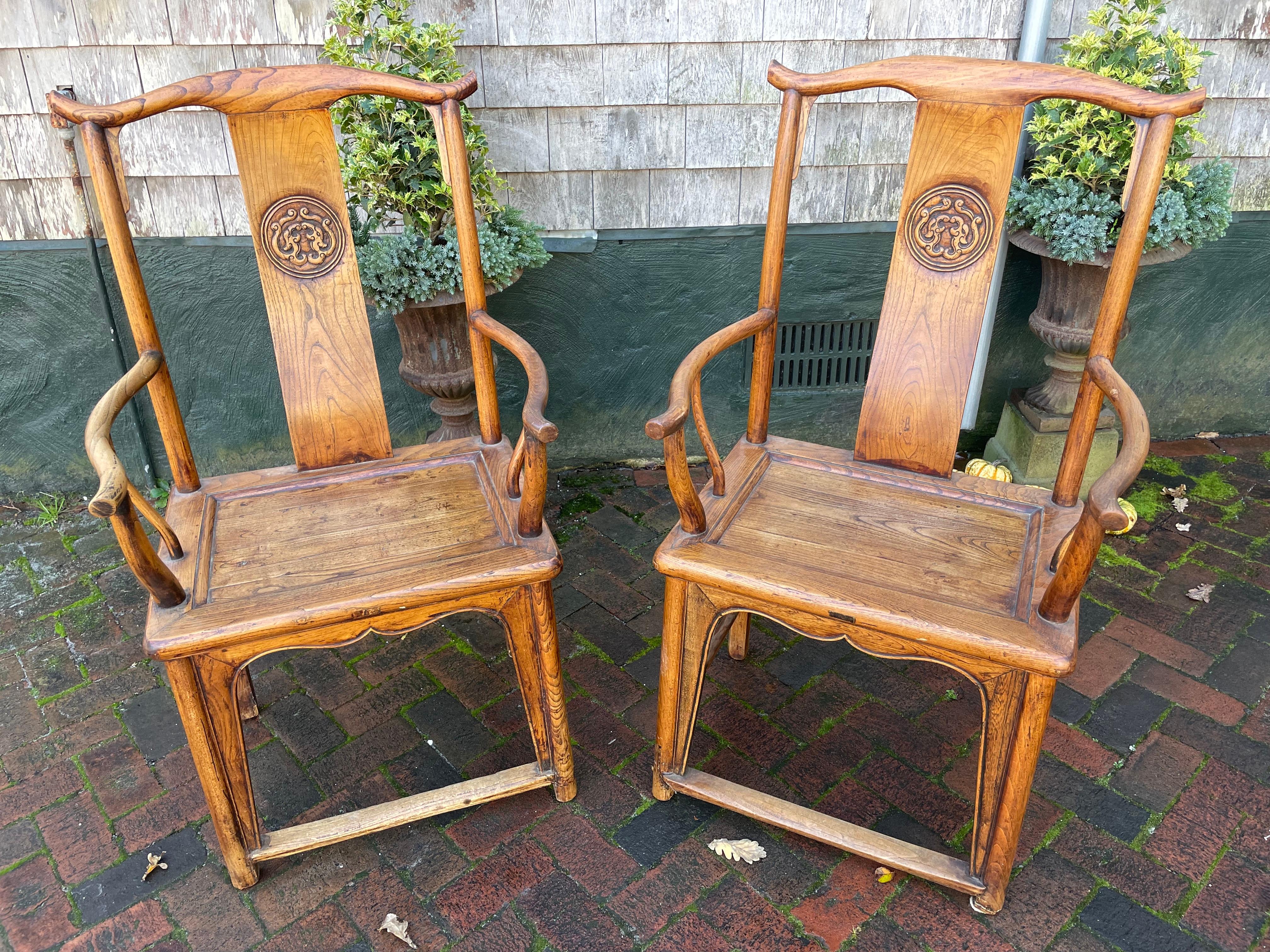 A pair of Chinese hardwood yoke-back chairs (Qing Dynasty) with carved back and tenon seat. 