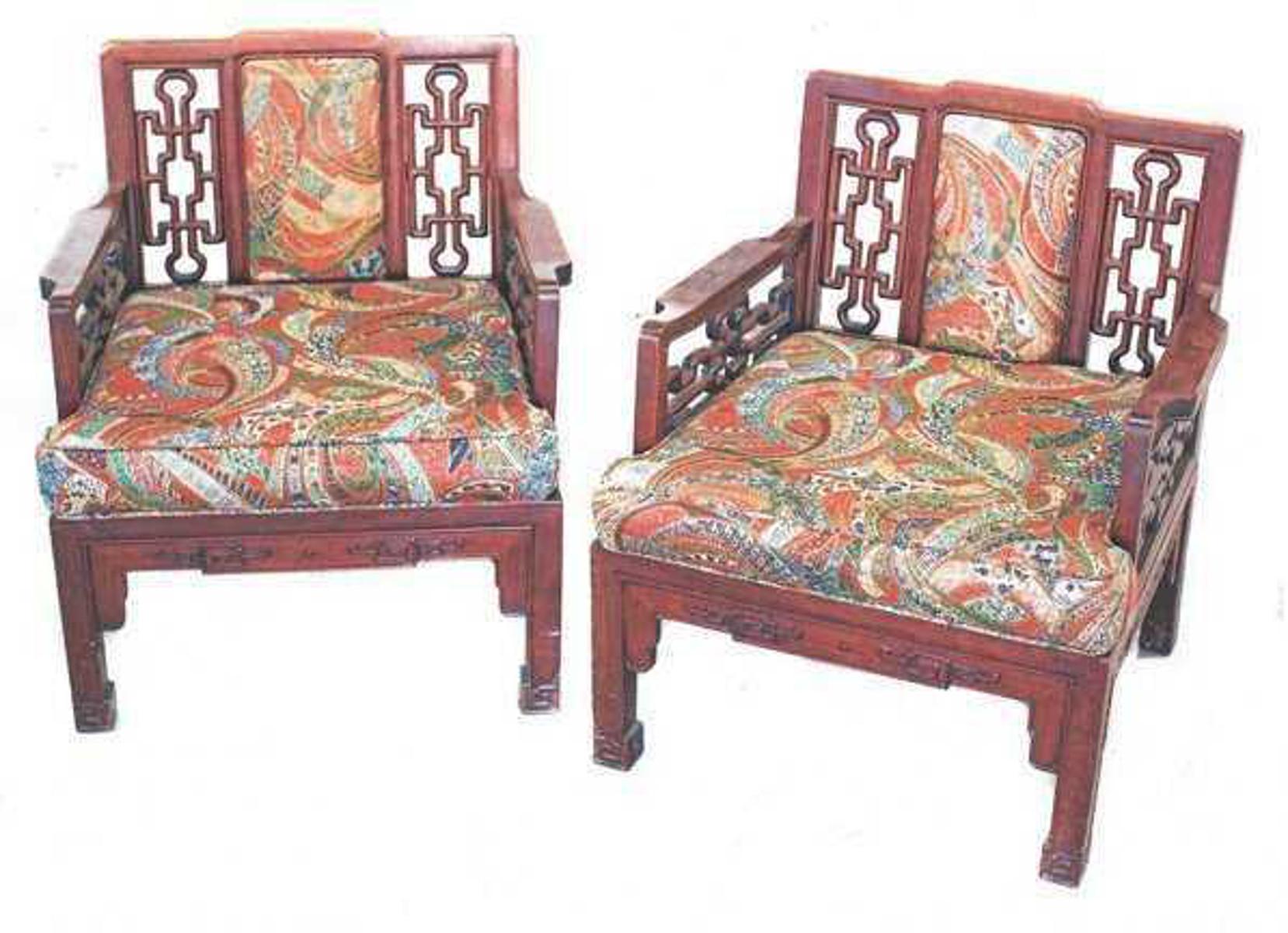 Pair of Chinese Hong-Mu armchairs.
Each shaped square back with an inset padded panel, flanked by open fretwork, the straight arms centering a plank seat, on straight legs, with associated loose cushions.
 