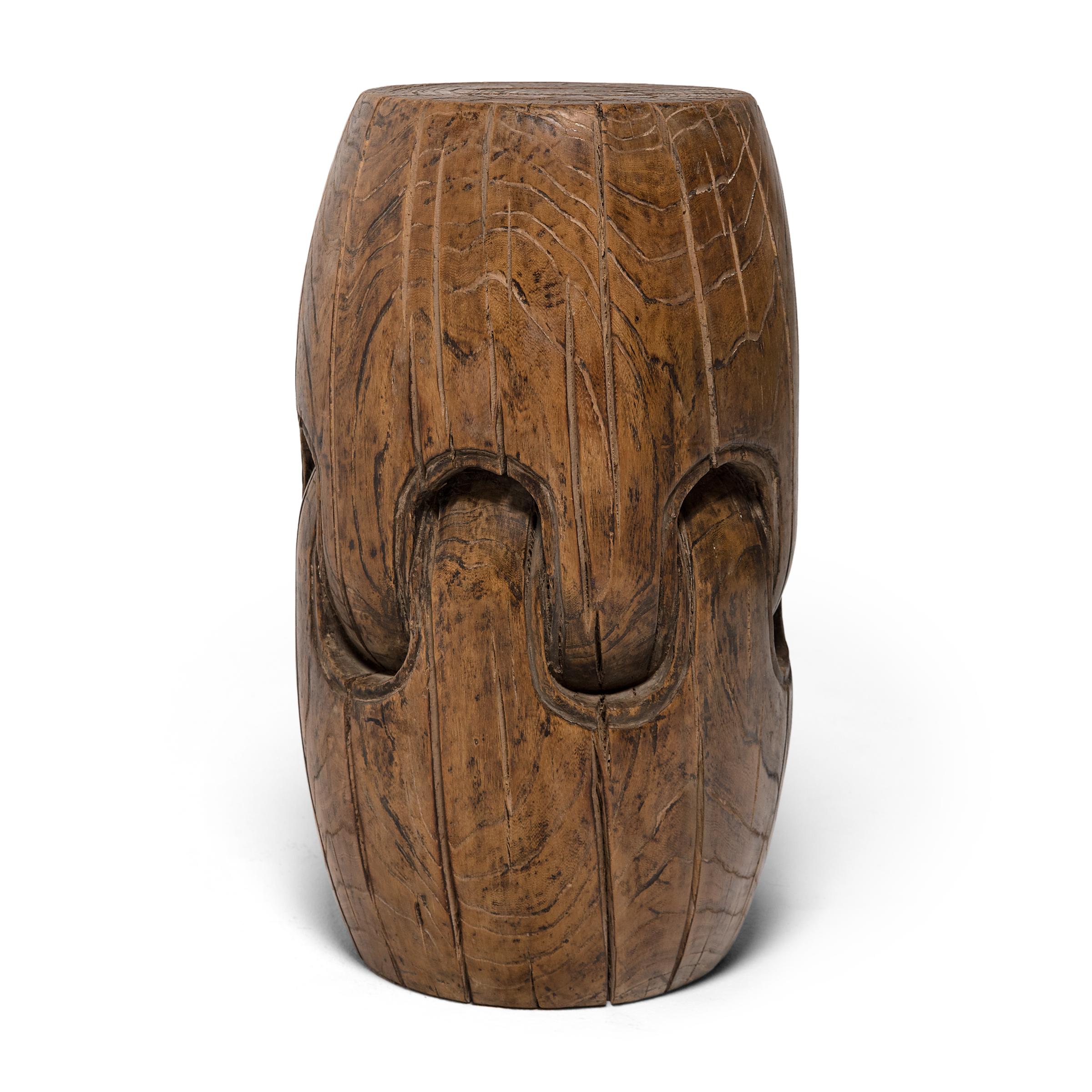 Carved from single blocks of cedar (nanmu), these unusual stools are a variation on the traditional barrel-shaped drum form popular in China since the Song dynasty. Minimally decorated, each stool gives the illusion of two smaller interlocking