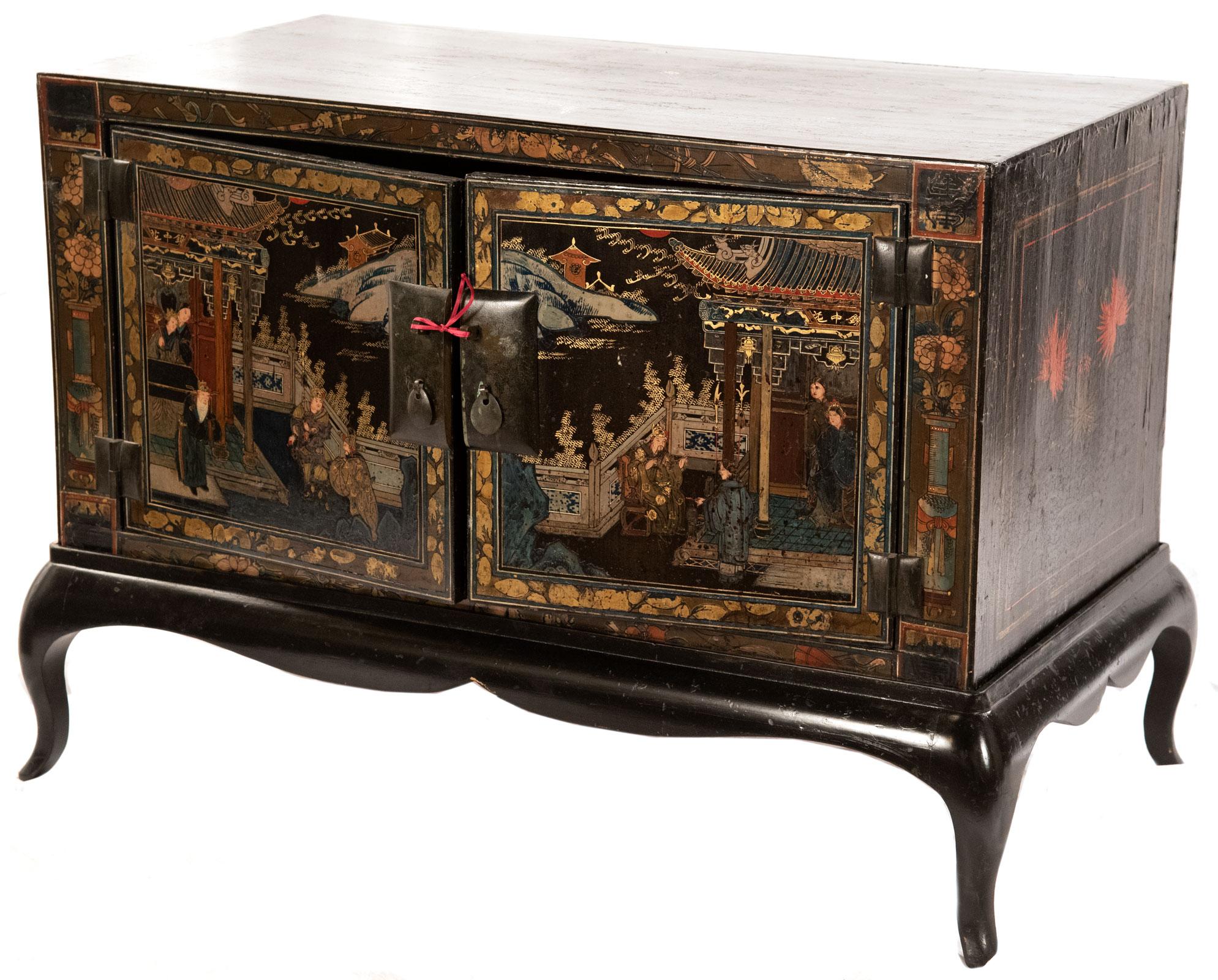 A pair of Chinese lacquered side table cabinets with scenes of courtly life in black, green, red and white on the exterior and red on the interior, circa 1920.