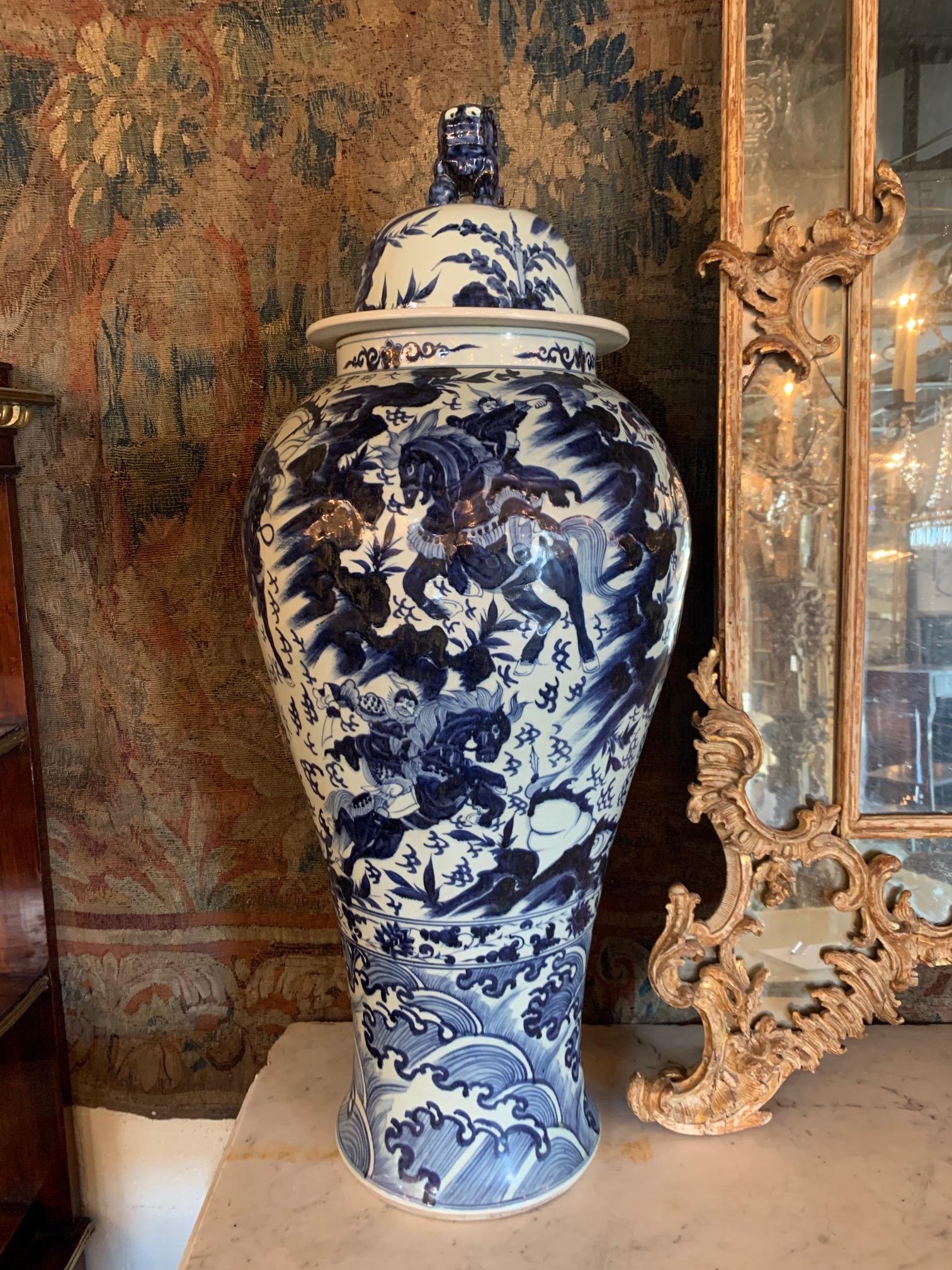 Exquisite pair of large scale blue and white lidded Chinese vases. Interesting images of a men on horseback. These are exceptional!