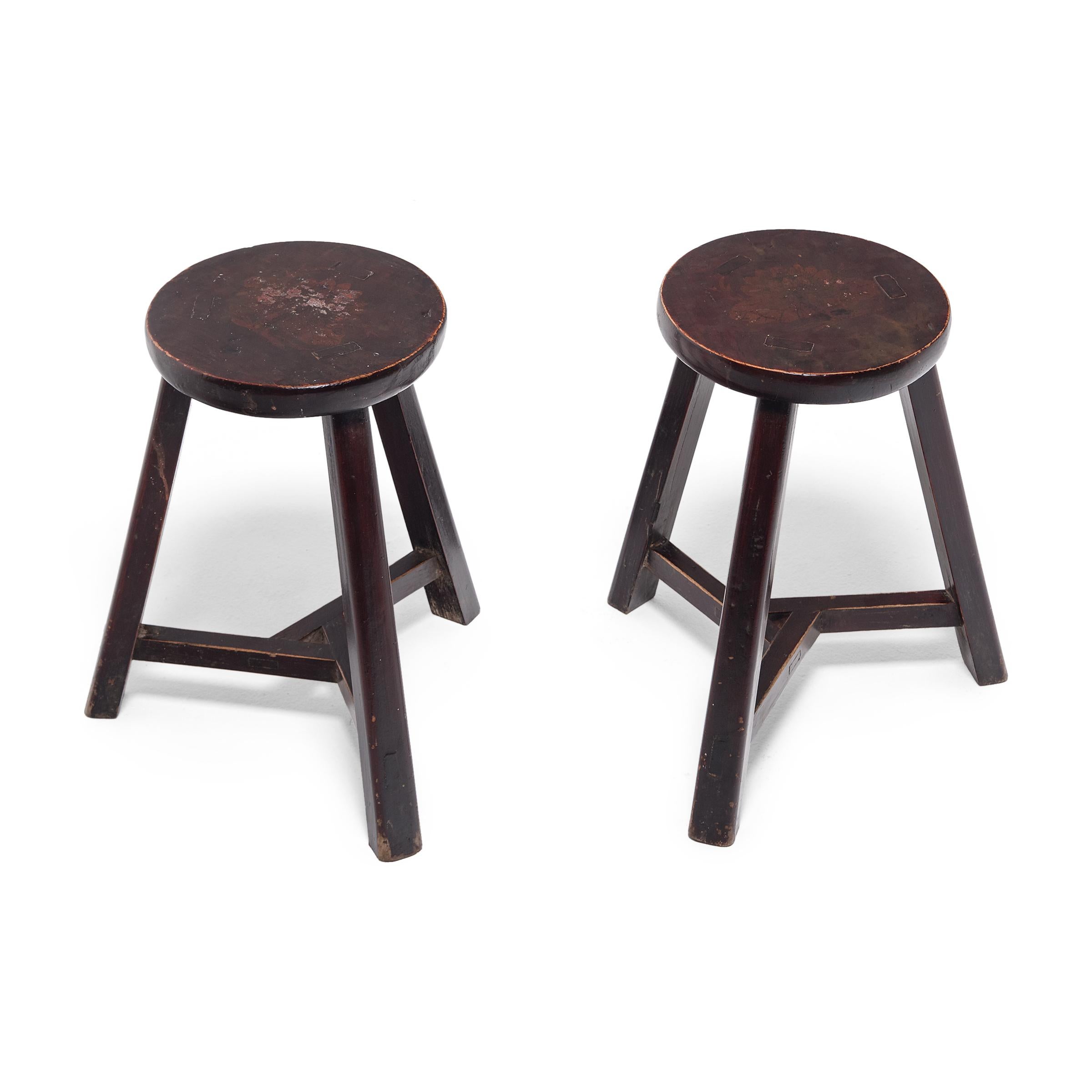 Deceptively simple, these early 20th century stools from Hebei province show off the ingenious joinery methods traditionally used by Chinese carpenters. The stool's three splayed legs are supported by stretcher bars that interlock at the center to