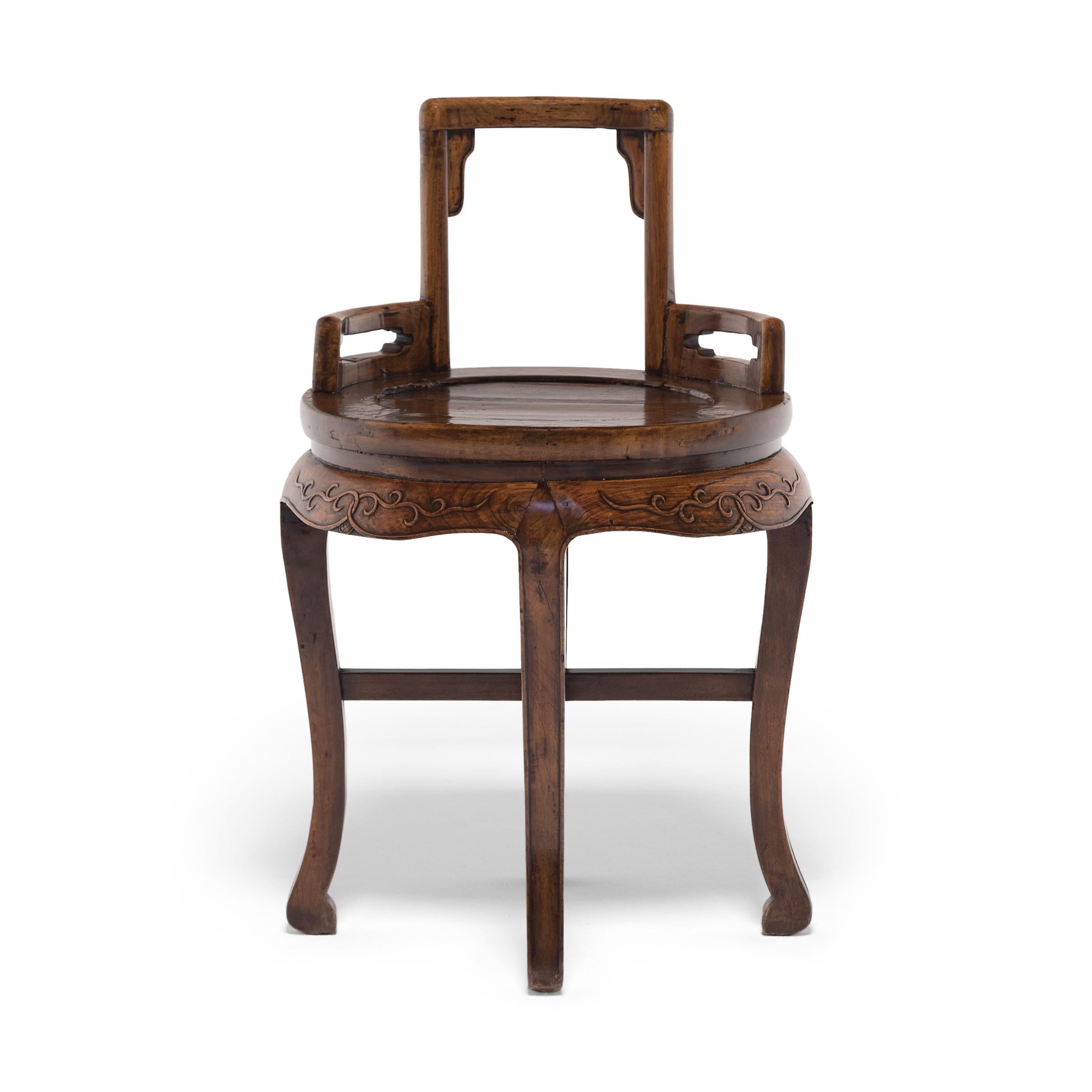 Dated to the late 19th century, these petite ladies' chairs combine the low, square backs of traditional rose chairs with the round frames and cabriole legs of waisted display tables. Each chair features an open back with shallow arms, curved to