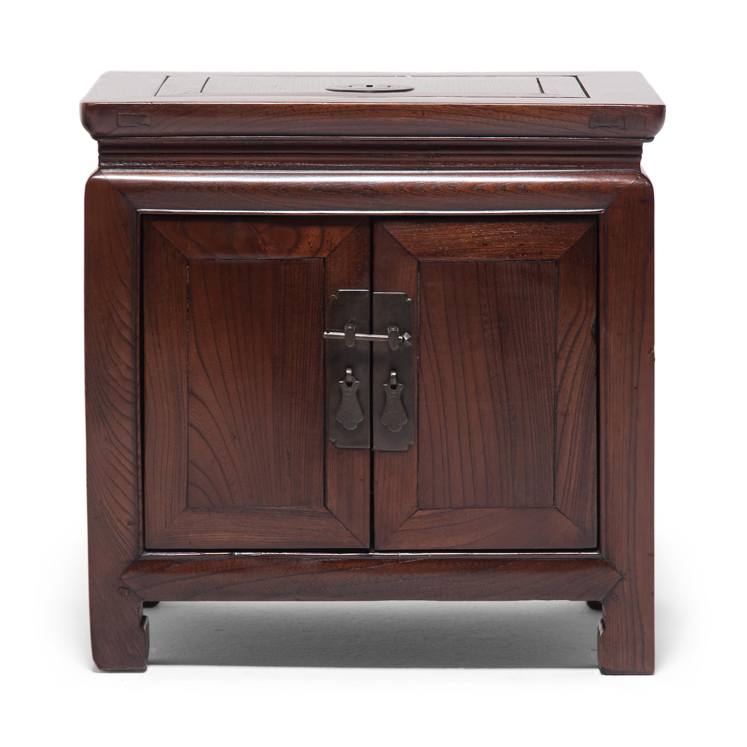 This adorable pair of low square chests were designed to be used as portable safes, used to store and secure money and other valuables for a Qing-dynasty merchant or household. The chests open two ways - the front opens by two doors secured by a