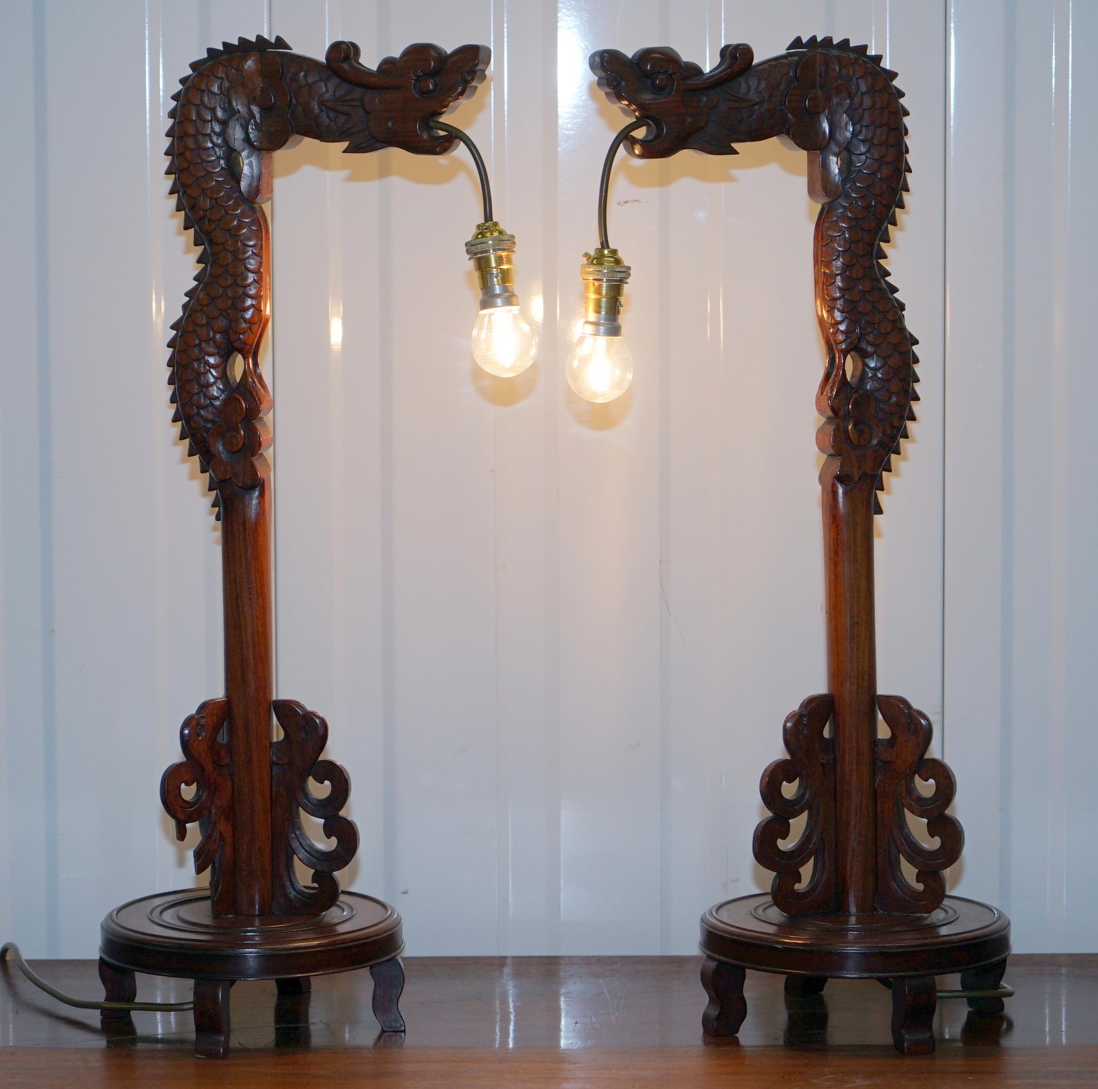 We are delighted to offer for sale this lovely pair of hand carved wood Chinese dragon table lamps

This pair is in lovely restored condition throughout, they have been cleaned waxed and polished, fully rewired with new cables, inline switches and