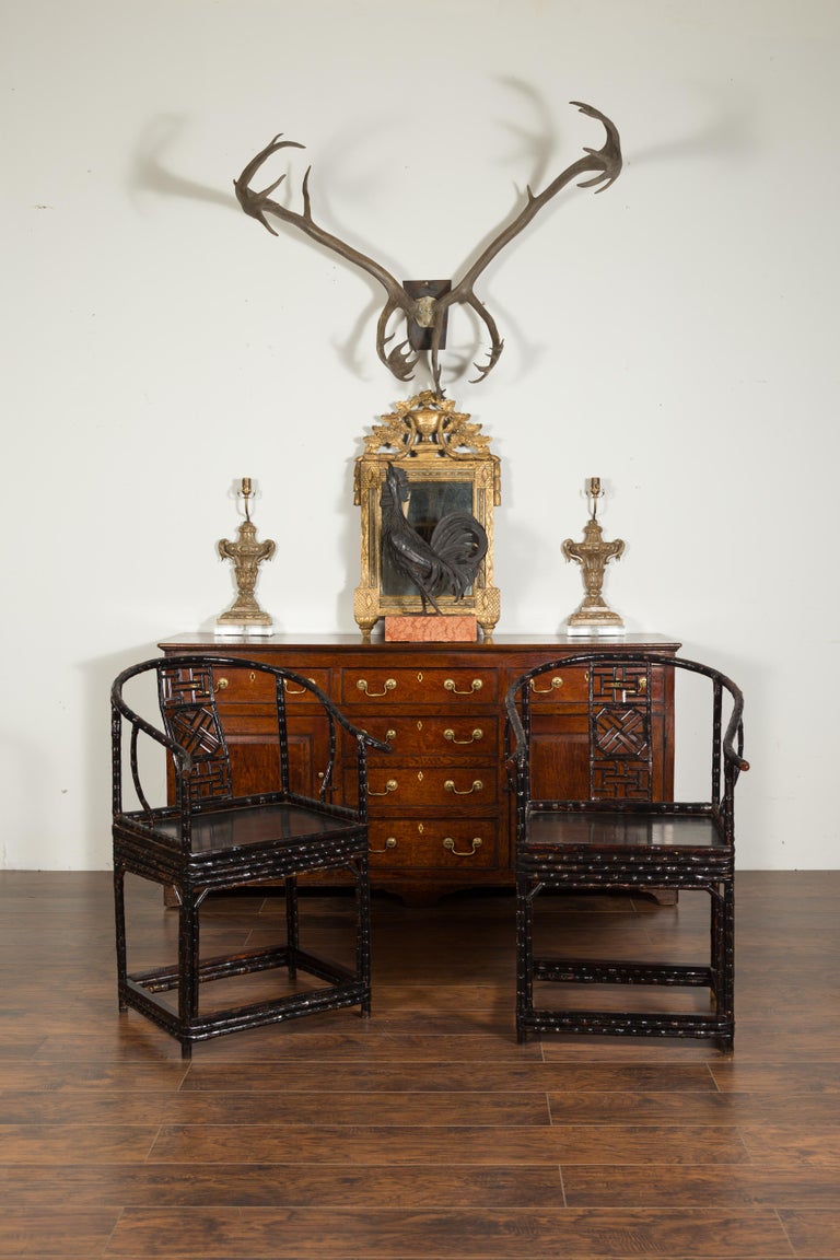 Pair of Chinese Ming Dynasty style 1920s horseshoe back bamboo armchairs a pair of Chinese Ming Dynasty style horseshoe back armchairs from the early 20th century, with fretwork motifs and dark patina. Created in China during the first quarter of