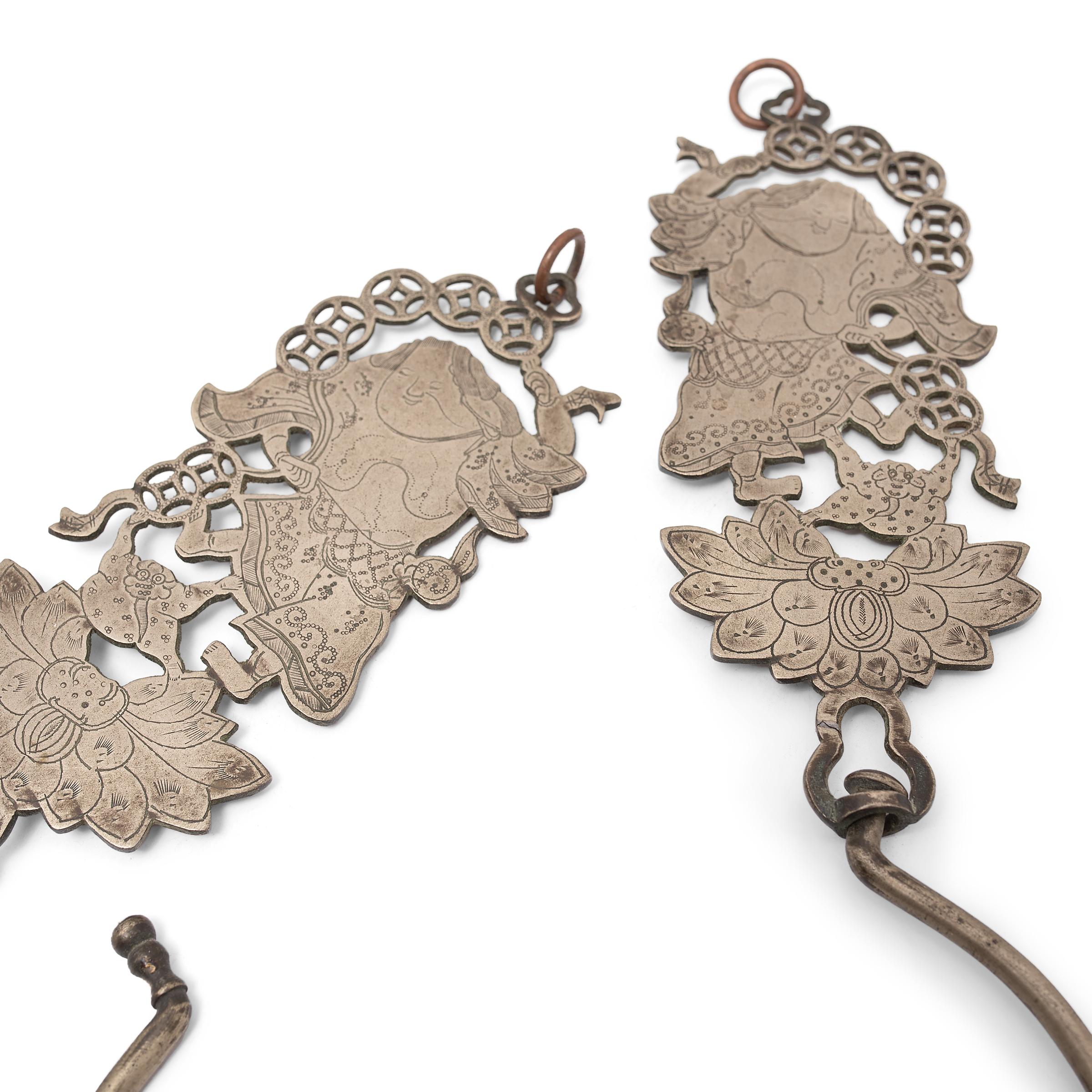 This fantastic pair of etched brass hooks recreates those used throughout the Qing dynasty to hold open the gauzy curtains of traditional canopy beds. Each of the large hooks is affixed to an etching of the Daoist immortal Liu Hai and his animal