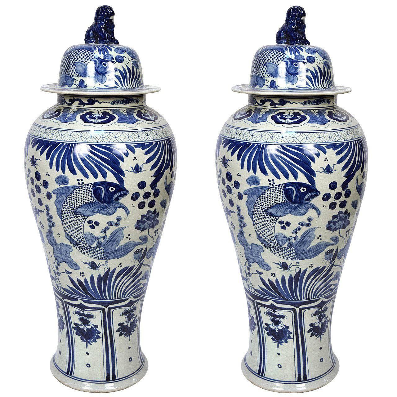 Pair of Chinese Monumental Blue and White Fish Jars with Shizi Tops