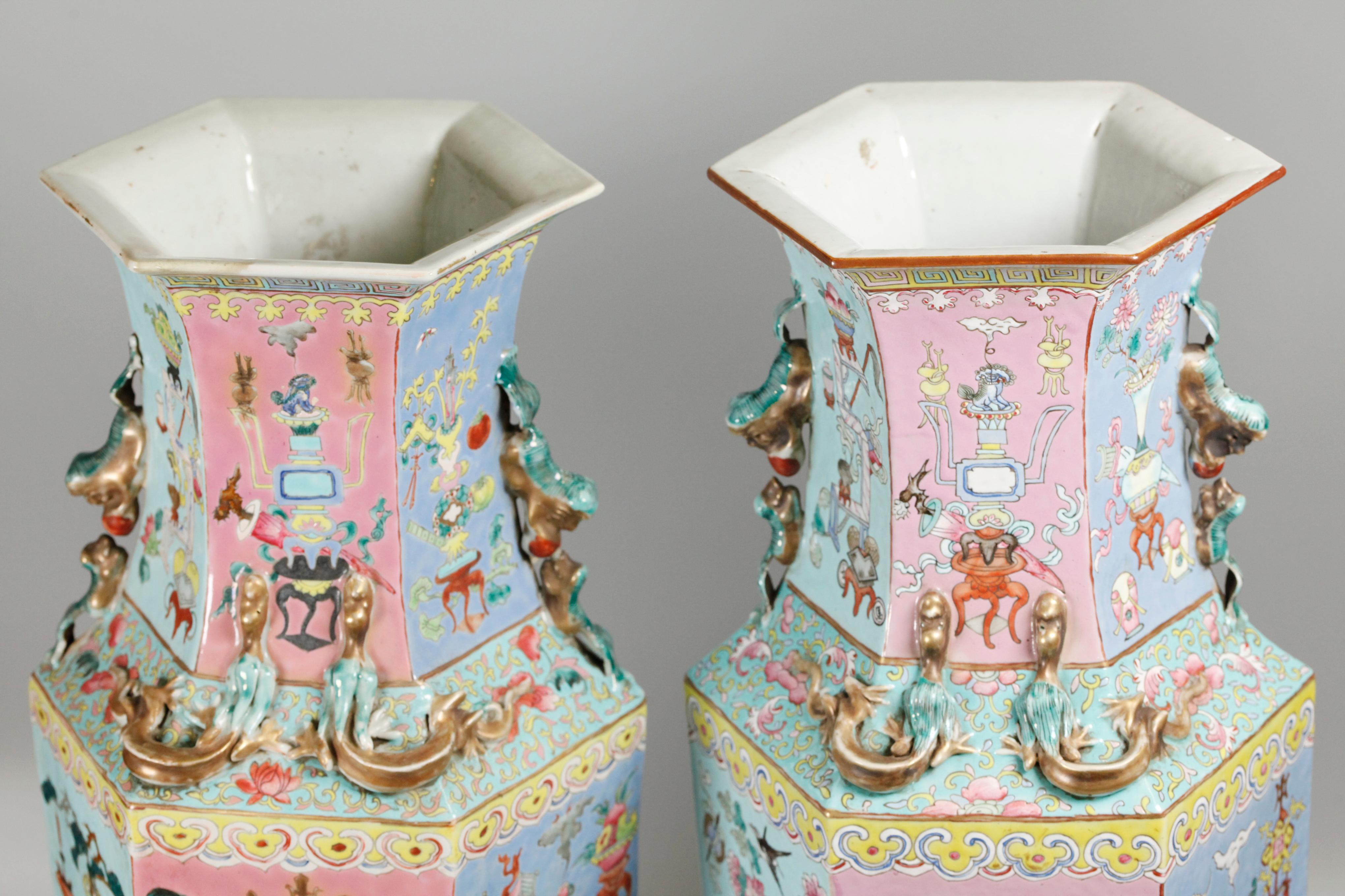 each vase is decorated with pastel colors; 10in(D) x 10in(W) x 24in(H) are the approximate dimensions of each vase including its fitted, hexagonal, wooden base