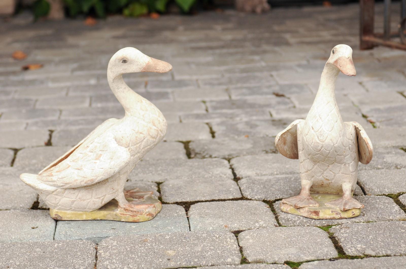 A pair of American carved and painted wood duck sculptures from the early 20th century. Made in the USA during the early years of the 20th century, this pair of sculptures is modeled on Chinese porcelain examples. They features two charming ducks