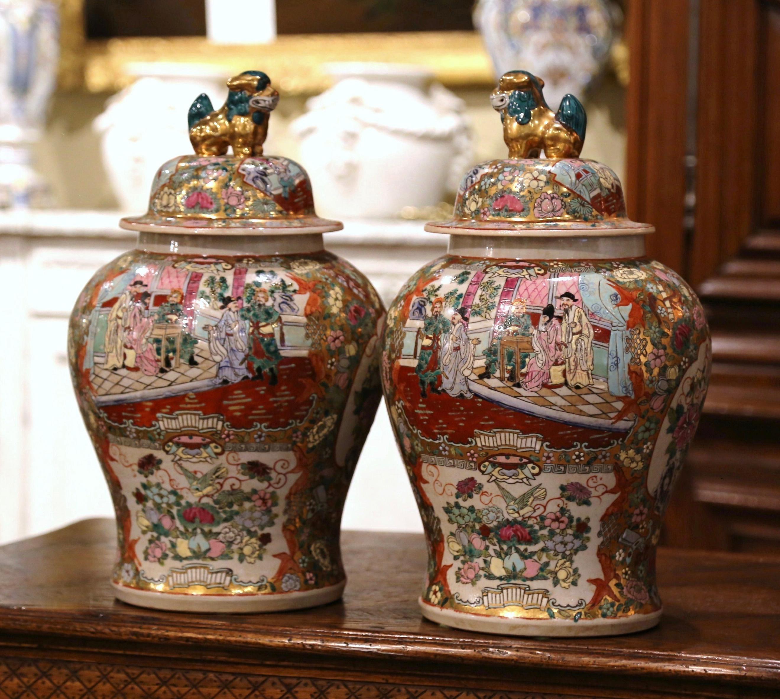 Decorate a console or mantle with this important pair of antique porcelain ginger jars. Created in China, circa 1920, each colorful vase is decorated with floral medallions and oriental scenes, and further embellished with hand painted Chinese