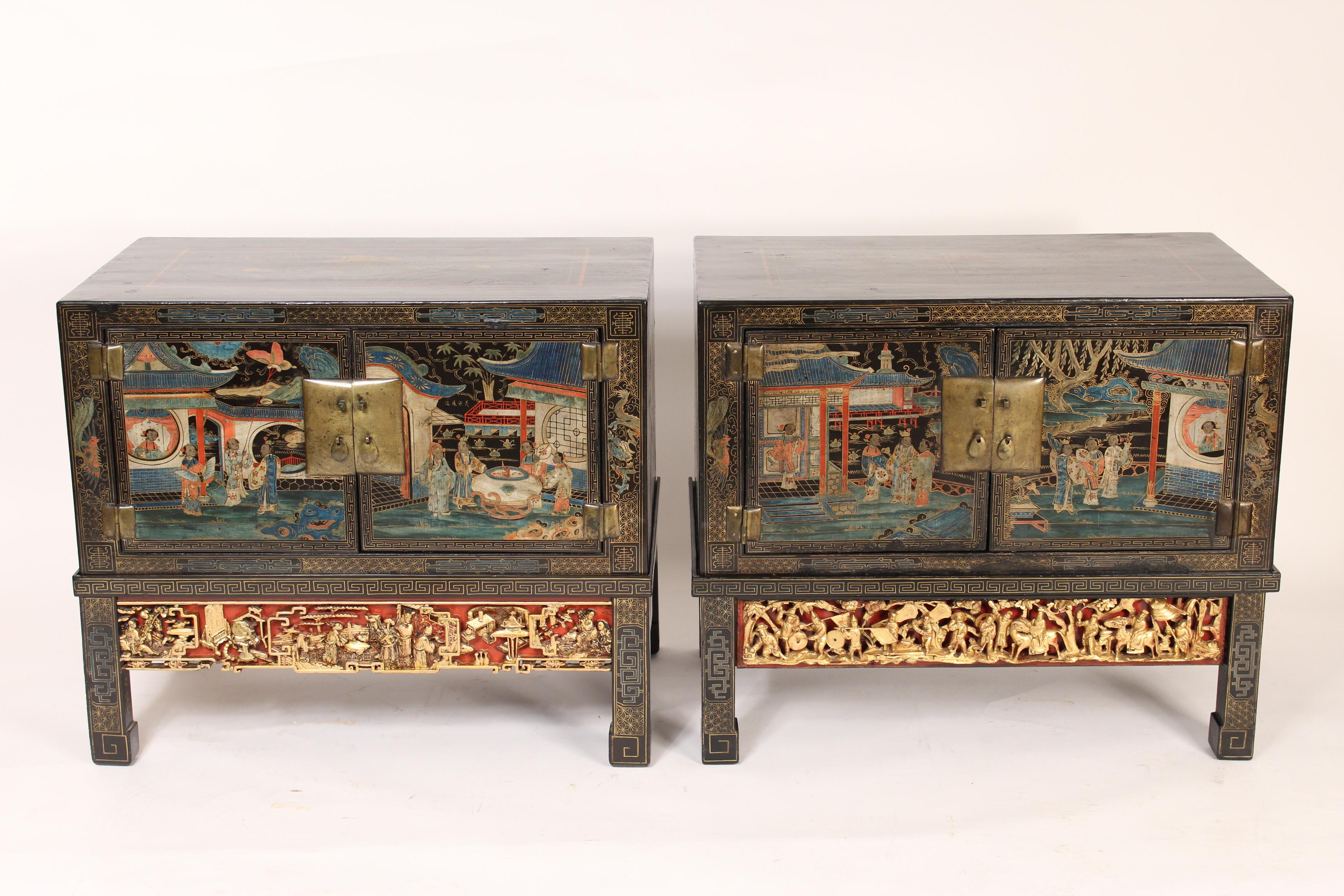 Pair of Chinese painted two door cabinets, on painted and carved giltwood stands, mid-20th century.