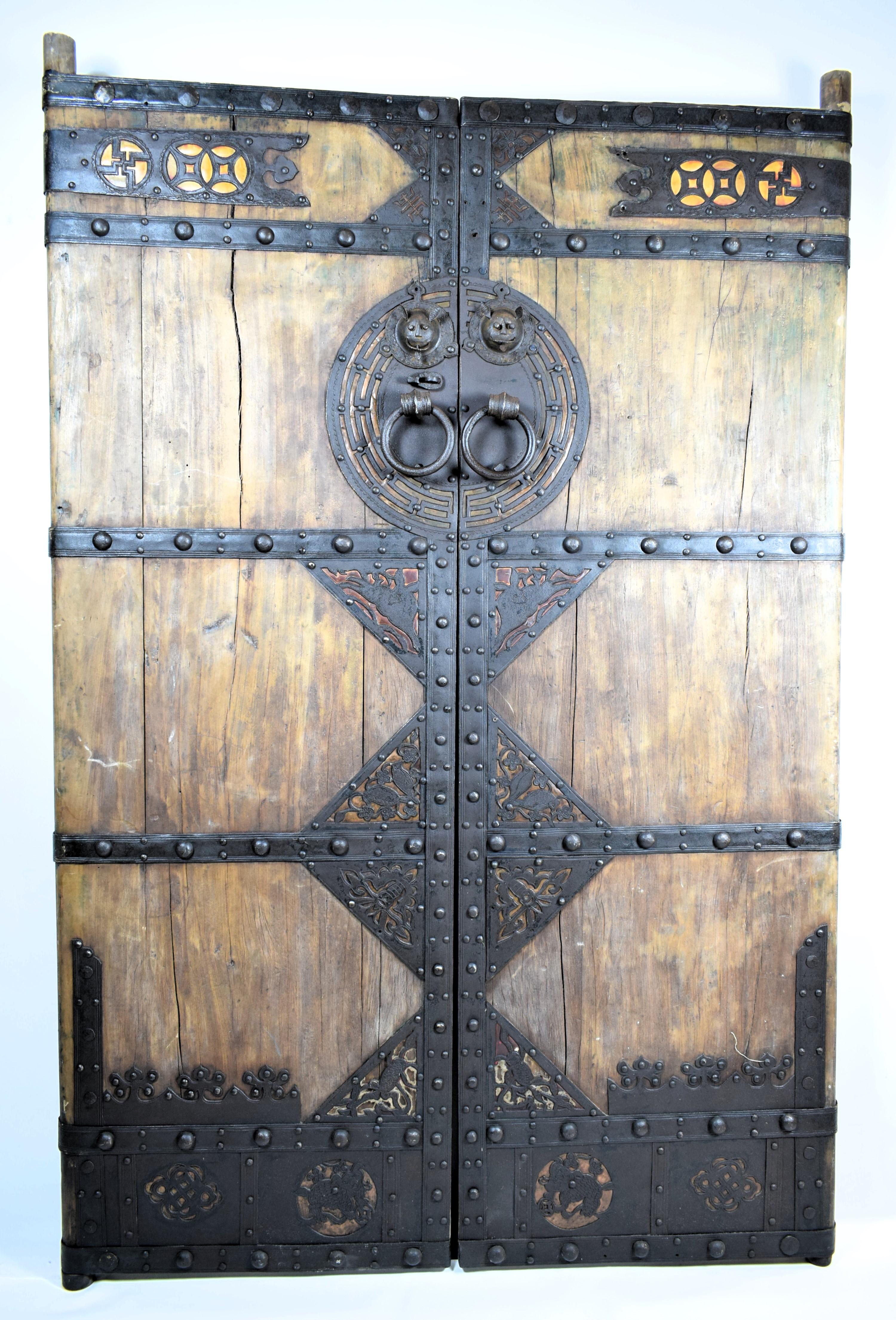 Pair of Chinese Palace  Wooden Iron Bound Courtyard Doors,  Late 19th Century Qing Dynasty Period
The grand wooden door from the late Qing Dynasty, showcases the craftsmanship of the era. This door is solid and imposing, made from rich, dark wood,