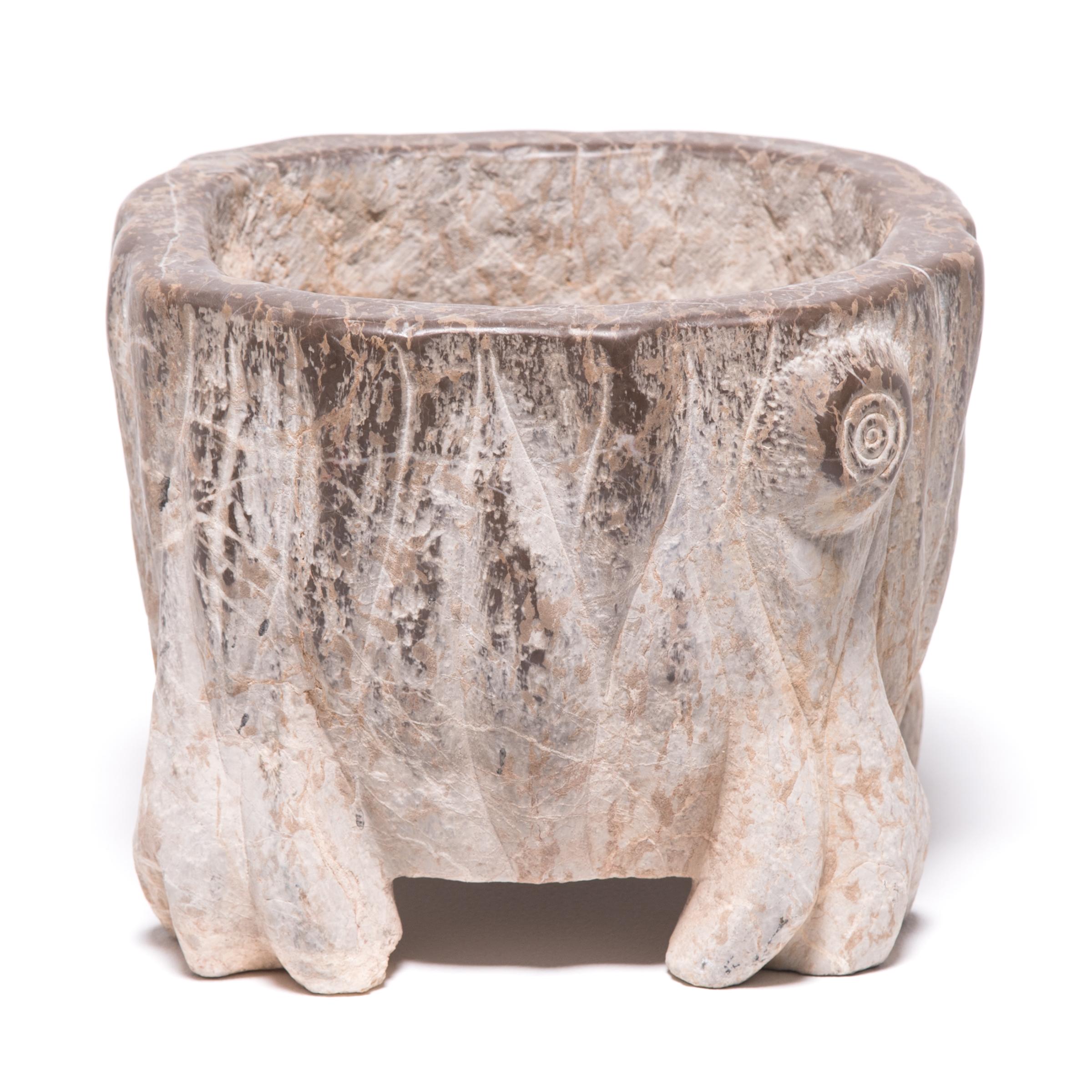 The artisan who carved this pair of petite basins skilfully called out the stone’s natural veining by delicately tracing the markings with carved vertical lines and shaping with subtle curves. The unusual feet suggest the paws of an animal or roots,