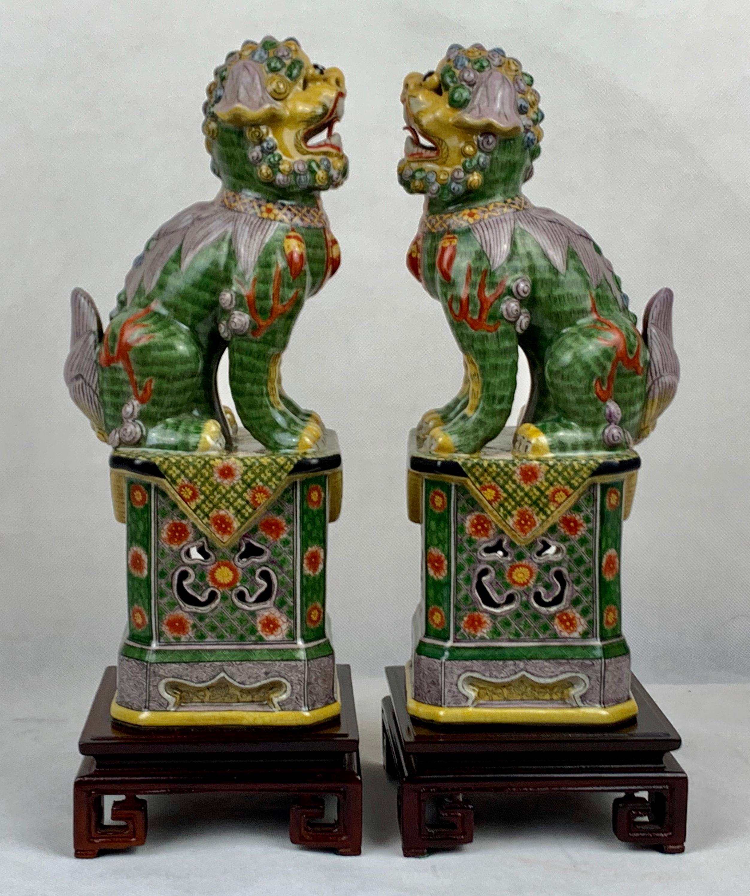 Pair of Polychromed Porcelain Chinese Foo Dogs on Stands-Green, Yellow, Red In Good Condition In West Palm Beach, FL