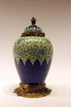 Pair of Chinese Porcelain and Enamel Bronze Mounted Urns with Tops
