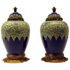 Pair of Chinese Porcelain and Enamel Bronze Mounted Urns with Tops