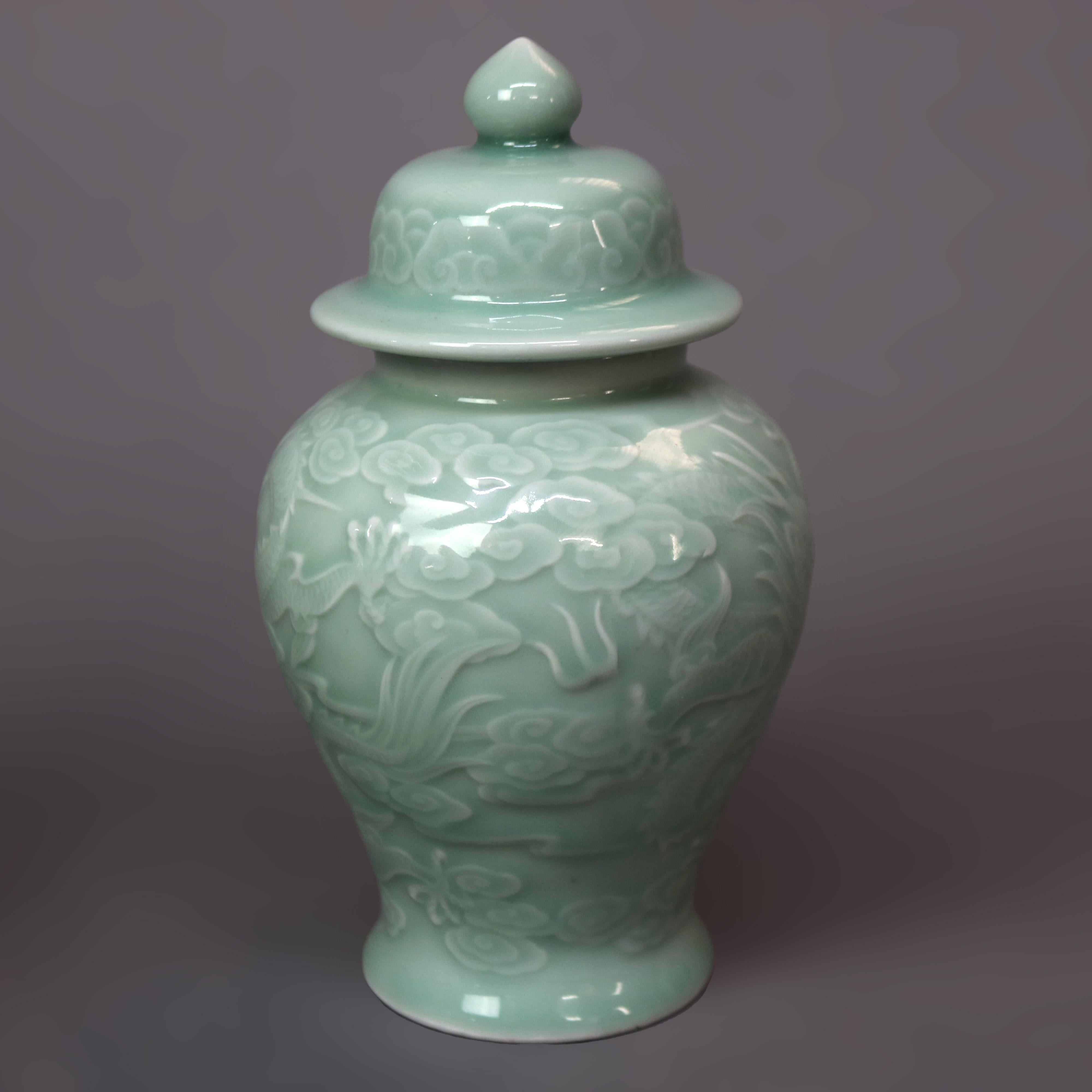A pair Chinese porcelain celadon lidded urns feature dragon design, 20th century.

Measures - 8.25