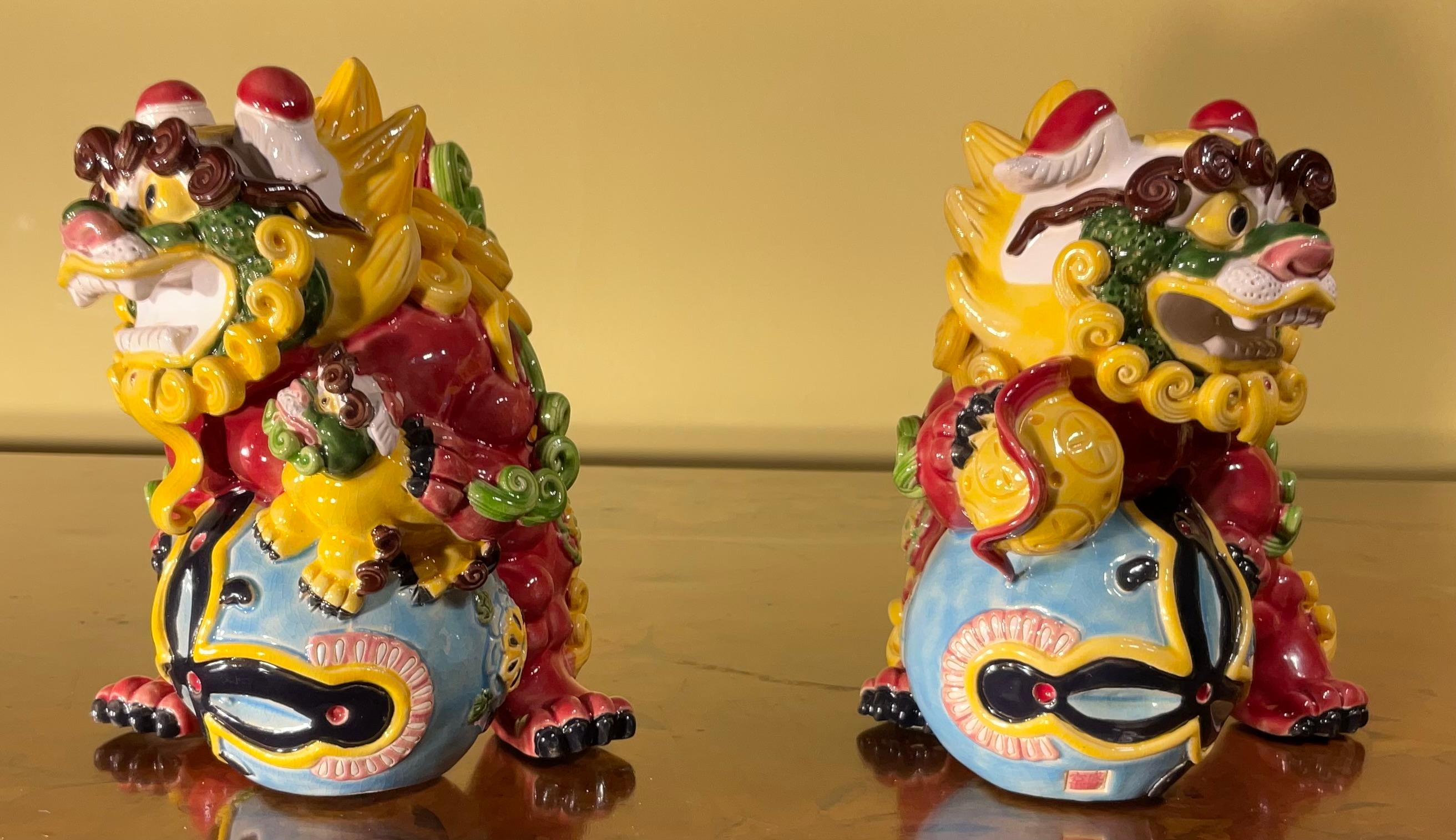 Pair of Chinese porcelain male and female foo dogs. The male foo dog seems to have a ball on his foot while the female has a baby foo dog on hers. Made in China, great vivid details with beautiful vibrant colours.
Exceptional object of art for