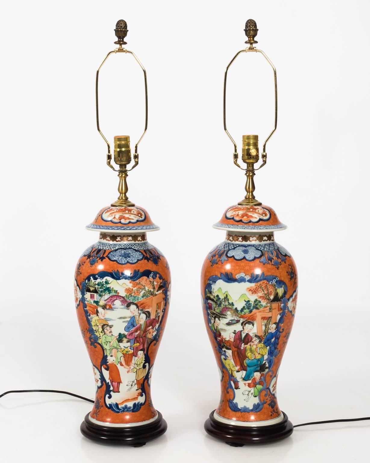 Pair of Chinese porcelain ginger jar lamps with scenic and figural decoration, circa 20th century. Custom pleated shades not included.
 