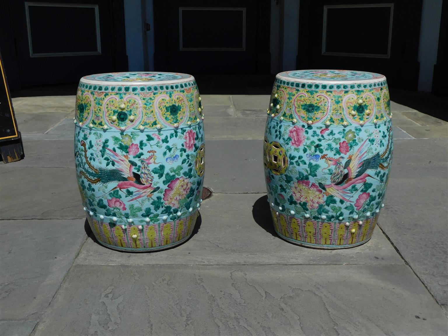 Pair of Chinese porcelain decorative painted foliage garden seats with flanking dragons, exotic birds, exterior bead work, and circular fret work, Early 19th century. Each seat measures 19