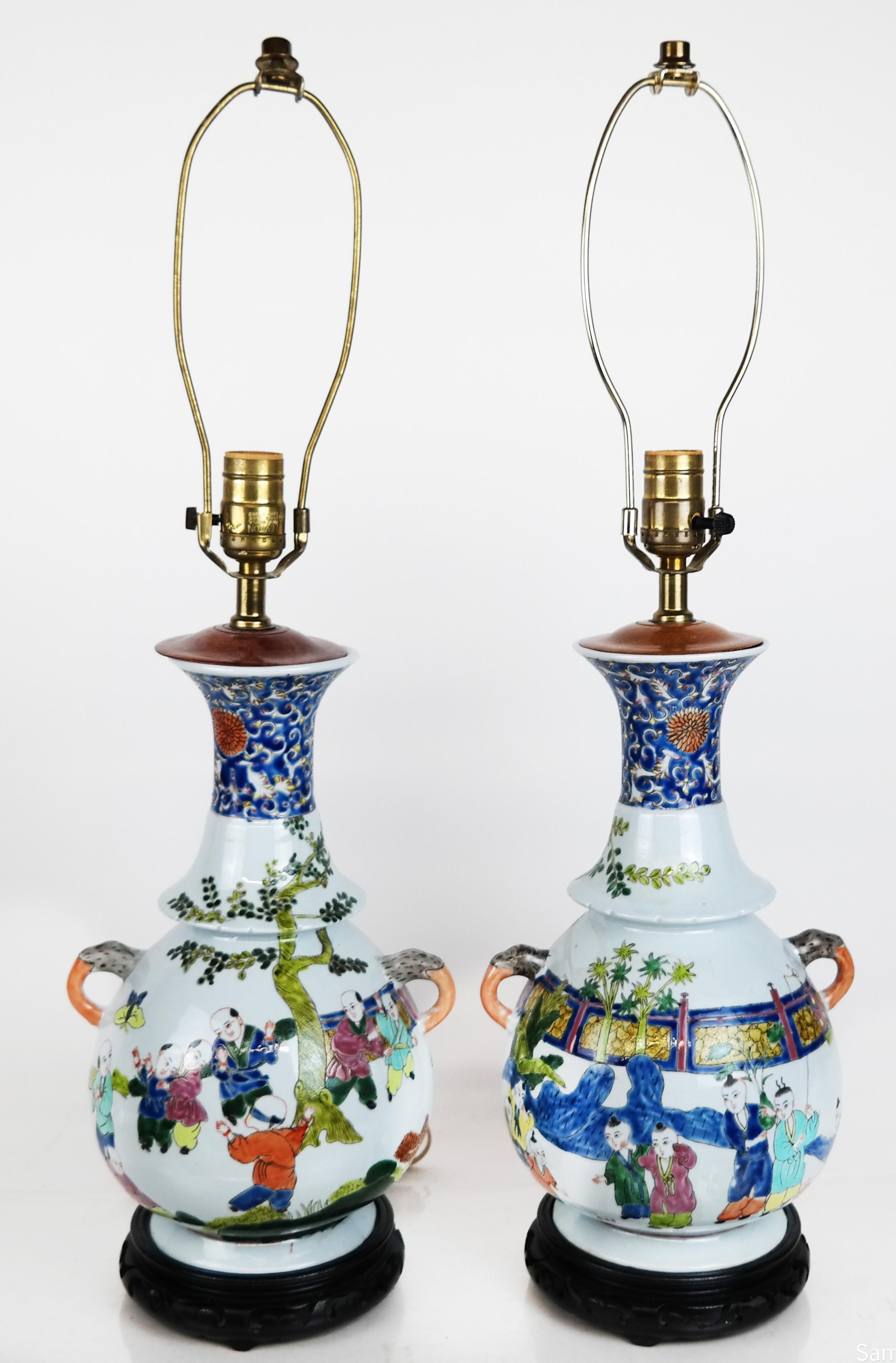 A pair of Chinese polychrome porcelain lamps with handles on each side and colorful figural scene.