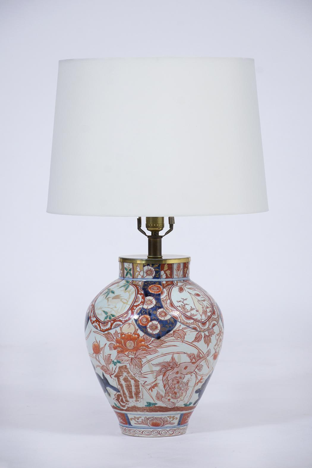 This pair of Chinese Porcelain table lamps are in great condition, are wired to US standards and are in working condition. Each lamp features a vase-shaped base with a colorful floral and animal design, brass lighting hardware, and brand new white