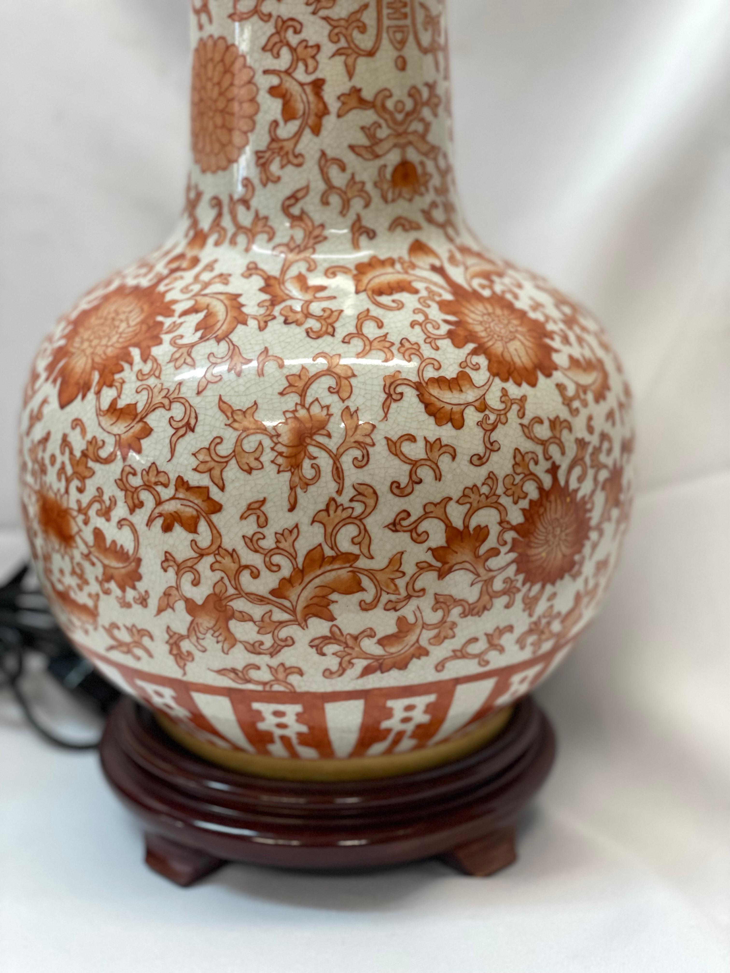Pair of Chinese porcelain table lamps with painted Lotus design on wood stands In Excellent Condition For Sale In San Francisco, CA