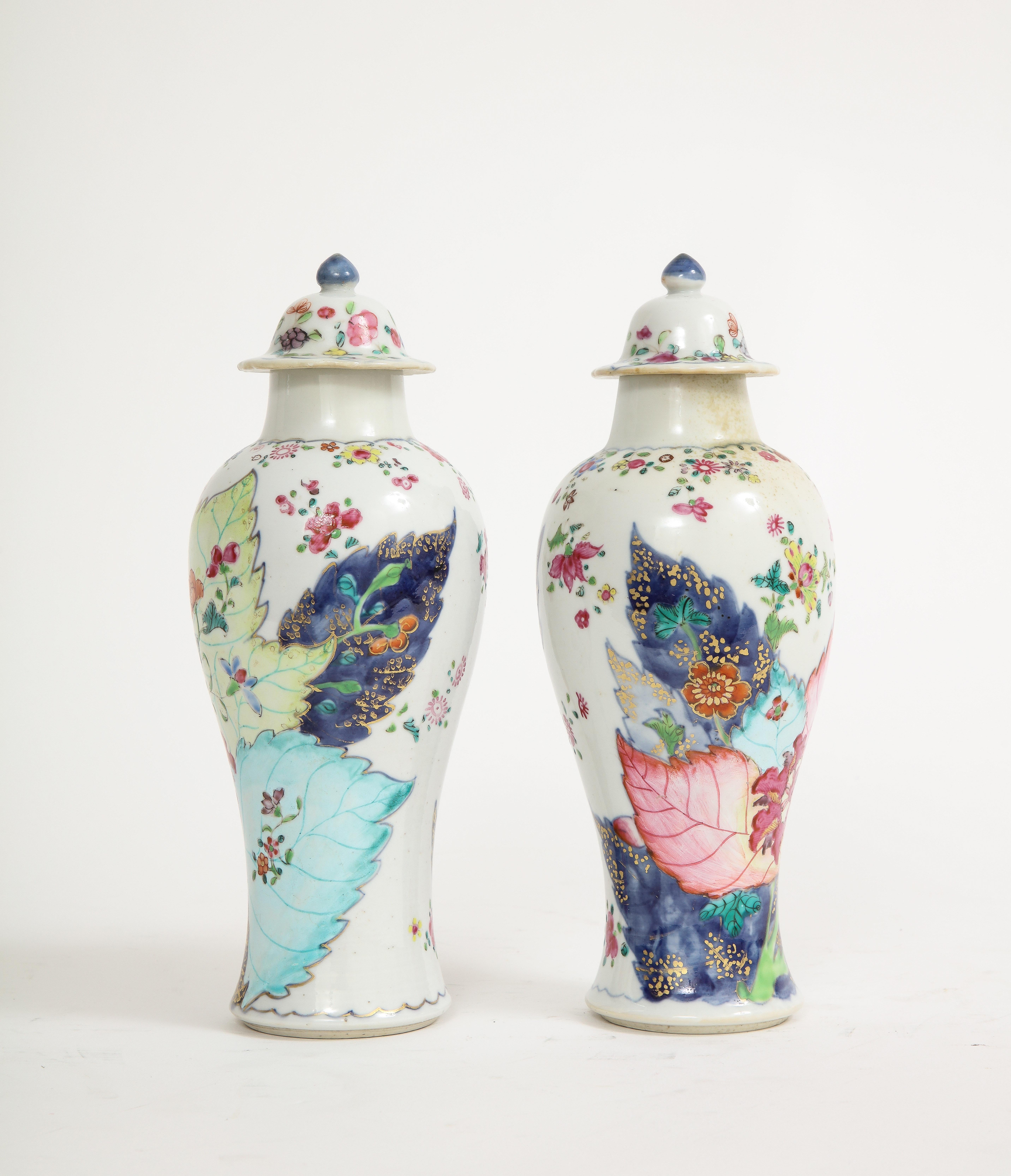 Each small vase richly enameled with the classic pattern in vivid famille rose colors heightened in gilt. A pair of tobacco leaf pattern vases of this quality and condition and very rare to find and are highly sought after. Tobacco leaf is a