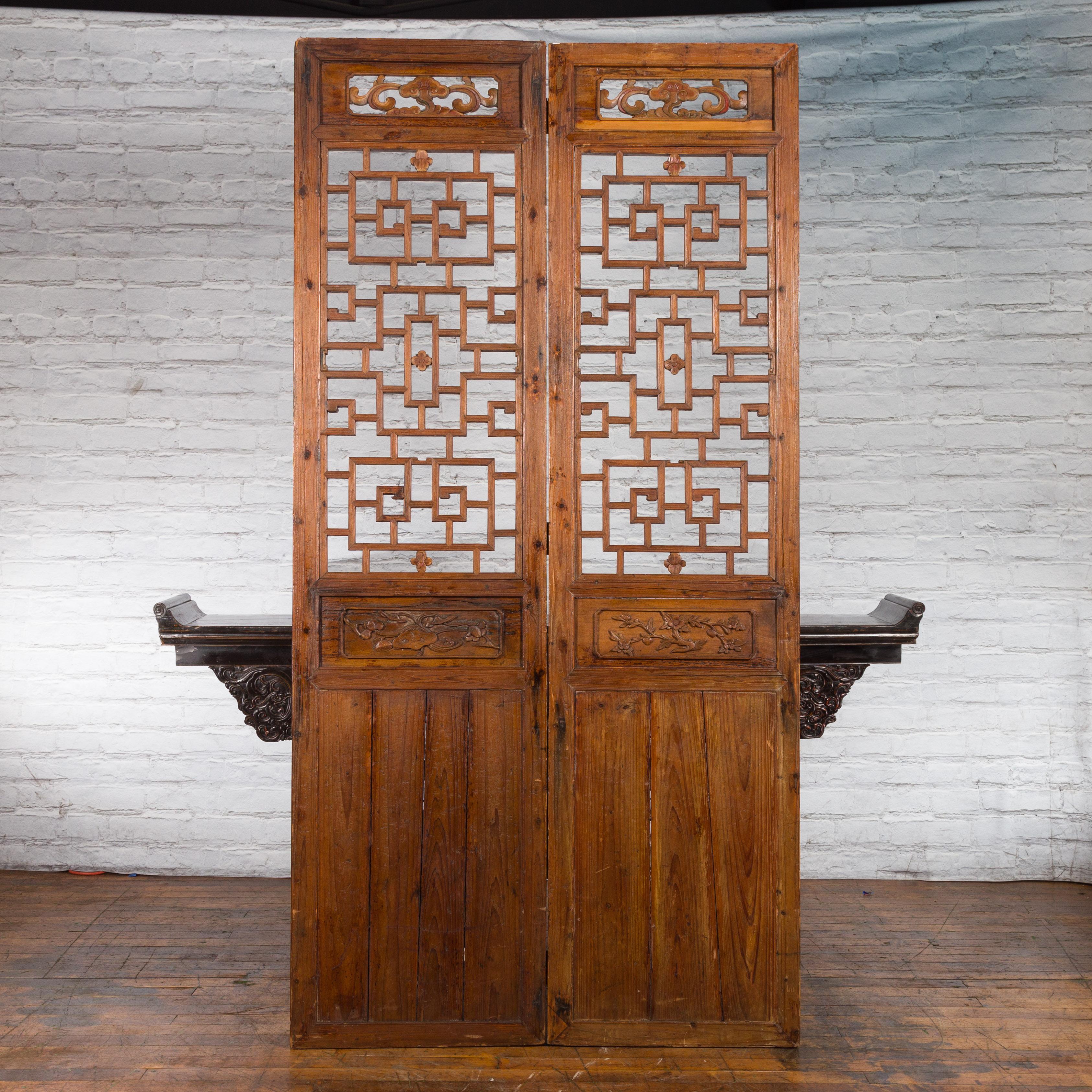 A pair of Chinese Qing Dynasty period large carved architectural panels from the 19th century, with fretwork. Created in China during the Qing Dynasty, each of this pair of architectural panels captures our attention with its fretwork motifs topped