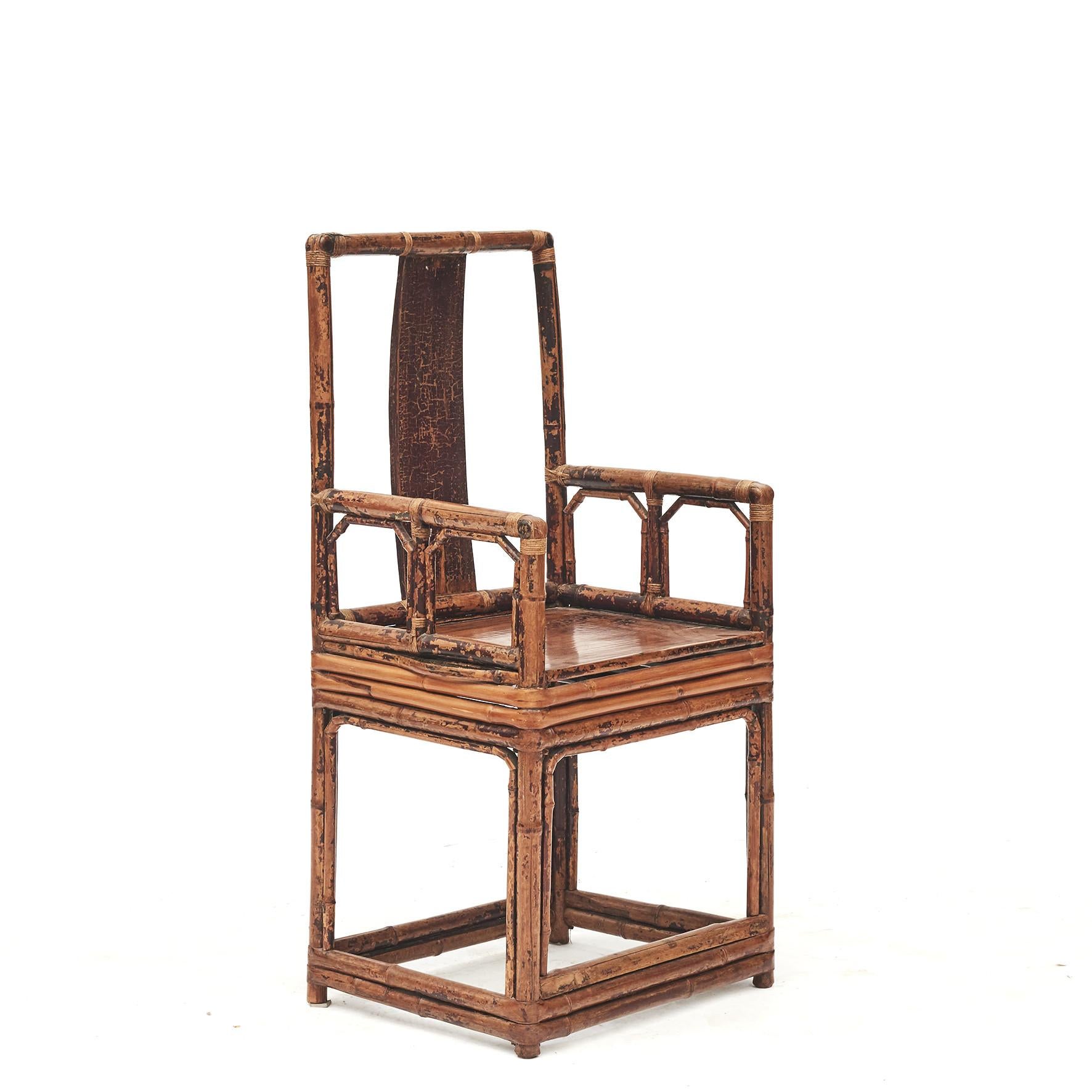 Pair of Chinese bamboo chairs each with wooden inset rectangular panel and seat.
Original condition with minor losses to the burgundy lacquer. Finished with a transparent lacquer which highlights the unique and natural patina.

From Jiangsu