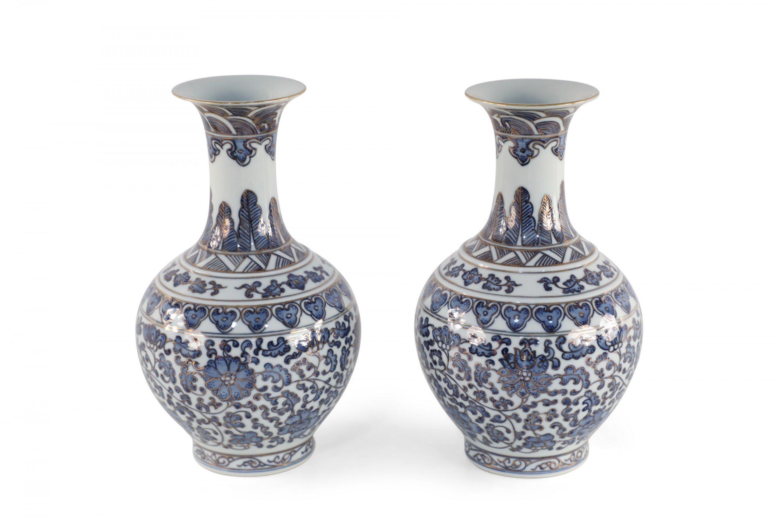 Pair of Chinese Qing Dynasty Qianlong period (18th century) globular, white porcelain vases with blue scroll and floral designs accented by gold line work. (date mark on bottoms) (priced as pair).
  