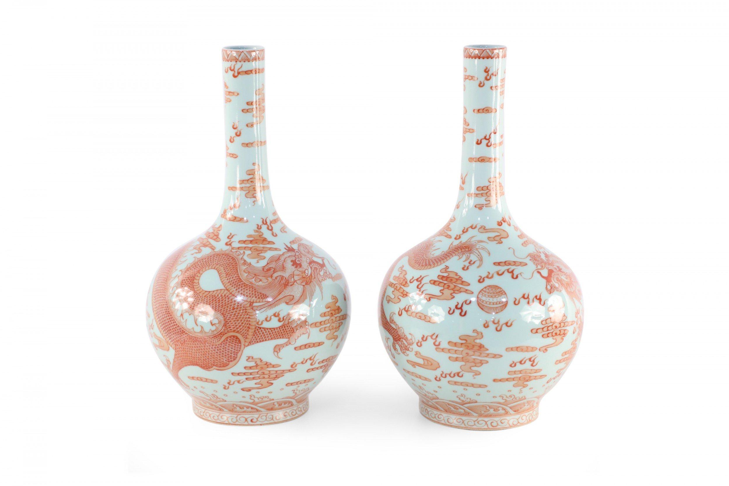 Pair of Chinese Qing Dynasty Yongzheng Period (Early 18th Century) light gray porcelain vases with globular forms wrapped in alum red glaze dragon motifs (date mark on bottoms) (PRICED AS PAIR) (Similar vases: NWL2048).
 
