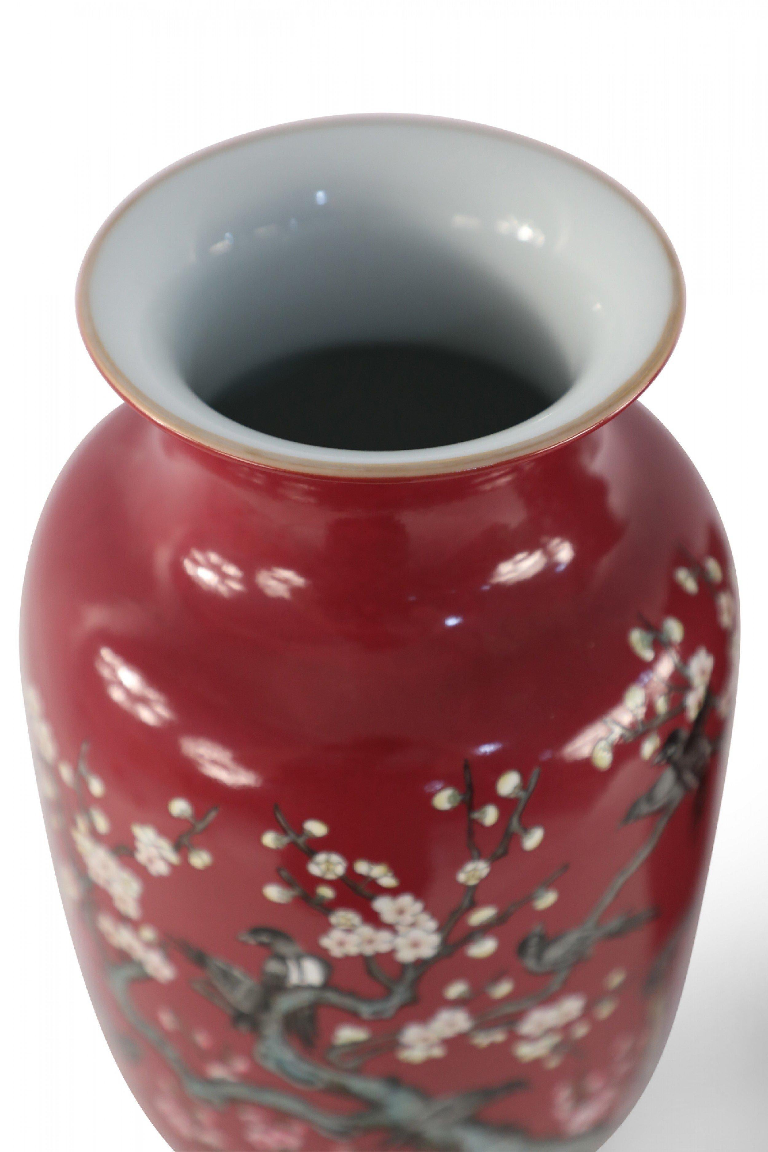 PAIR of Chinese Qing Dynasty Qianlong Period-style (early 20th Century) red porcelain sleeve vases decorated with plum blossoms and magpie birds, which together carry the auspicious message 