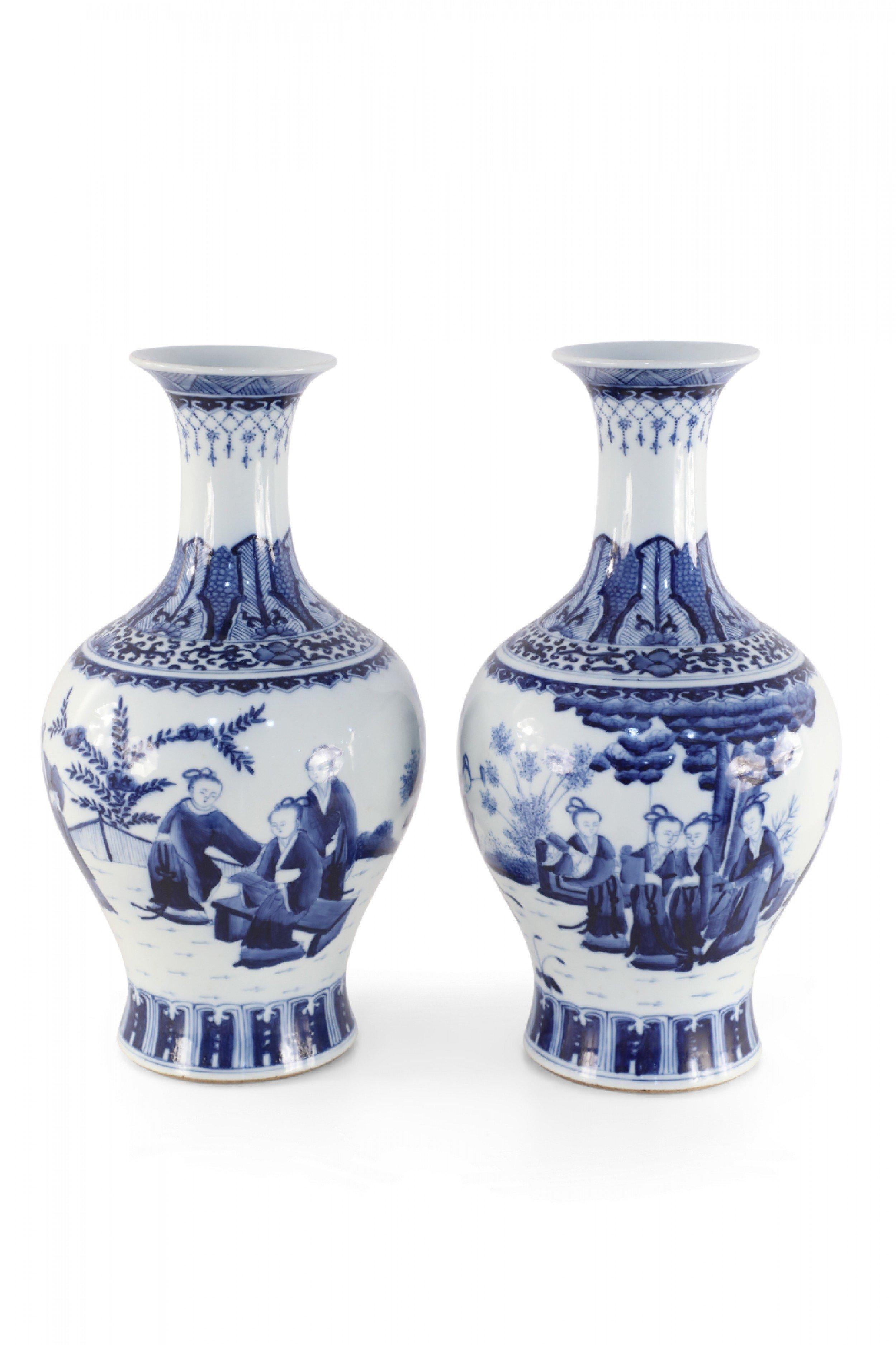 Pair of Chinese Qing Dynasty Kangxi Period (Late 17th to Early 18th Century) white and blue, pear-shaped porcelain vases depicting women in a pastoral setting and decorative patterns along the neck (date mark on bottoms) (Priced as pair).
 