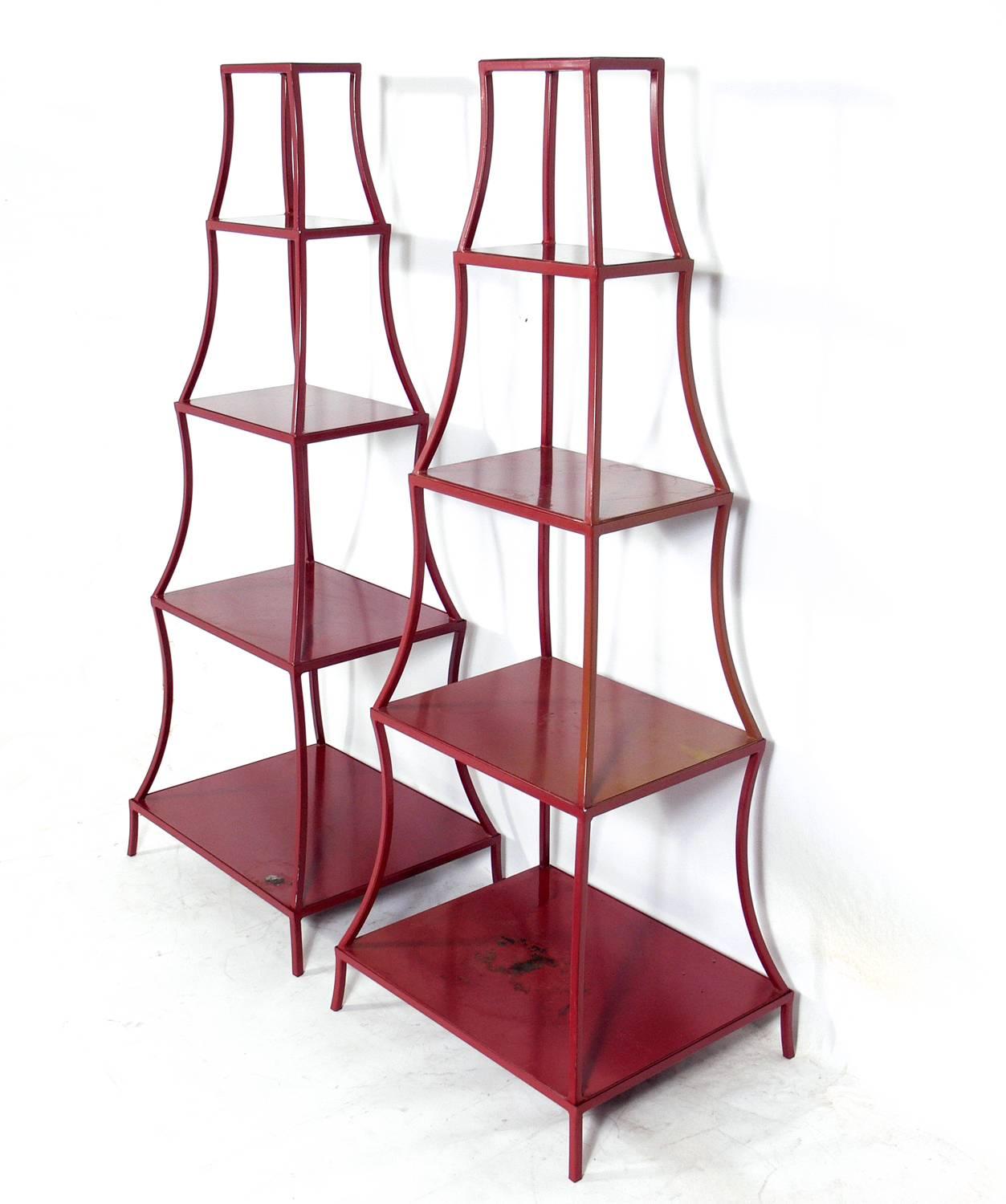 Pair of Chinese red color pagoda shelves, probably American, circa 1970s. They are a versatile size and can be used as bookshelves, display vitrines, or even as a bar. They are made up of four stacking sections in each unit, and can be easily broken