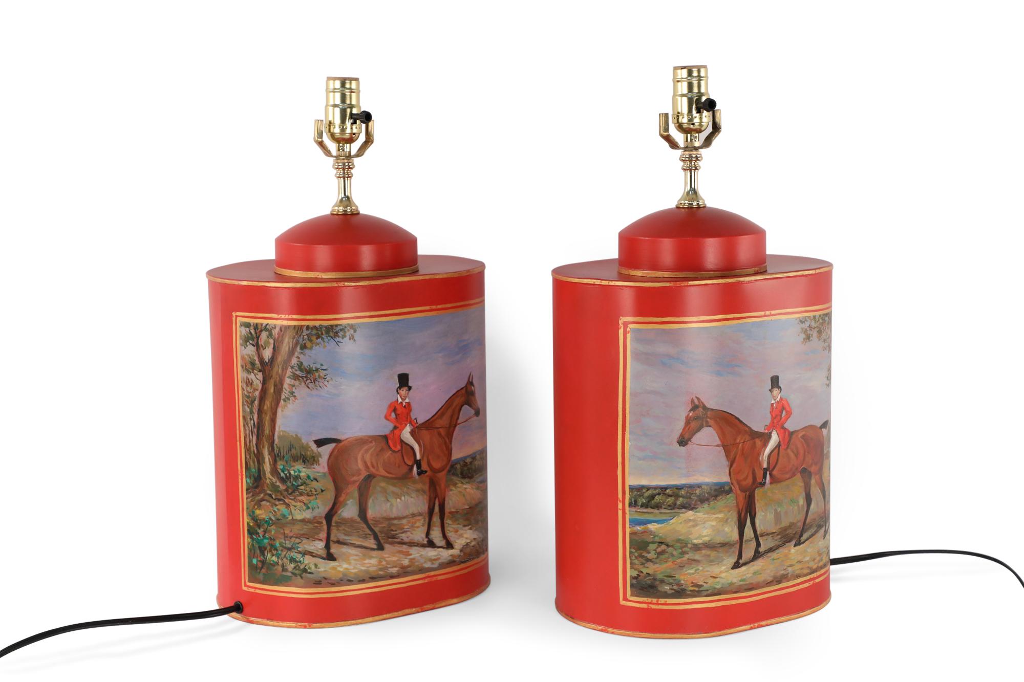 Pair of Chinese red and gold tole table lamps with canister-shaped bodies and brass hardware featuring an equestrian scene typical of 19th century European paintings.
