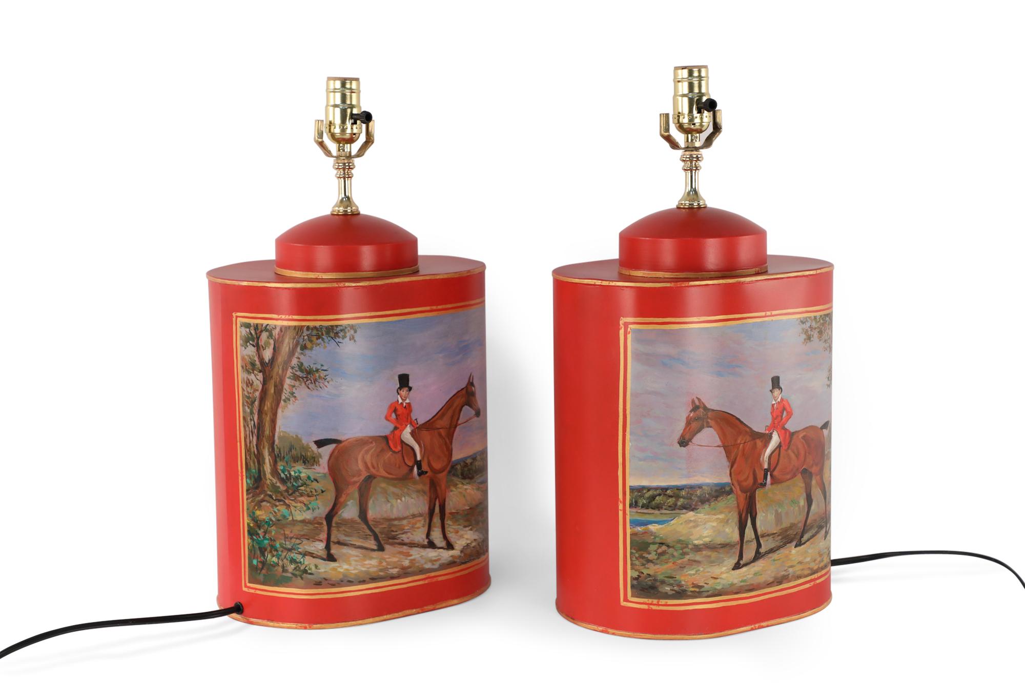 Pair of Chinese red and gold tole table lamps with canister-shaped bodies and brass hardware featuring an equestrian scene typical of 19th century European paintings (PRICED AS Pair).

Ships without shades.
