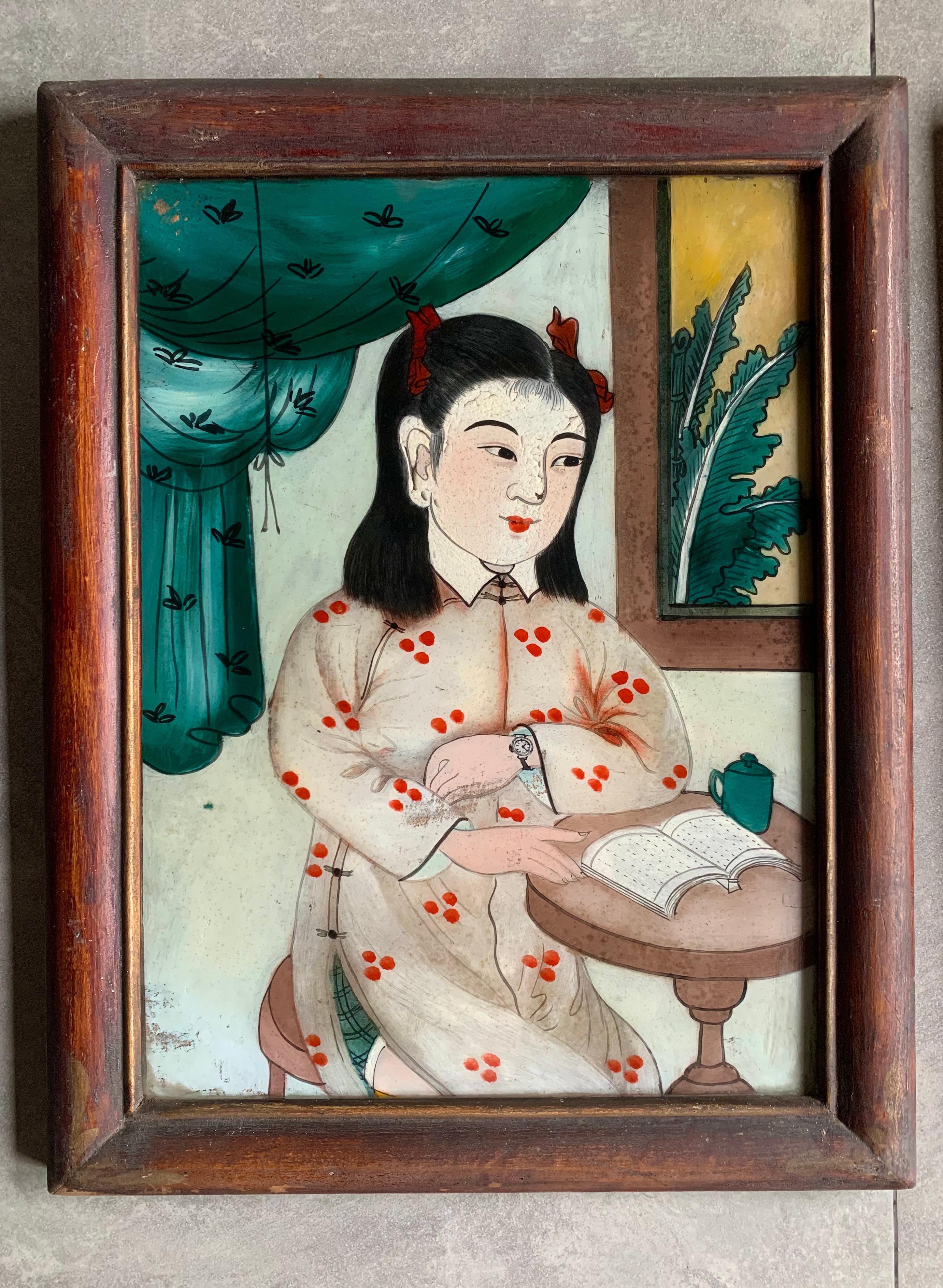 This pair of Chinese portraits depicting young women were painted using a reverse glass painting technique. Painting in reverse on the opposite side of a piece of glass meant the painter had to work in reverse. They still possess much of their