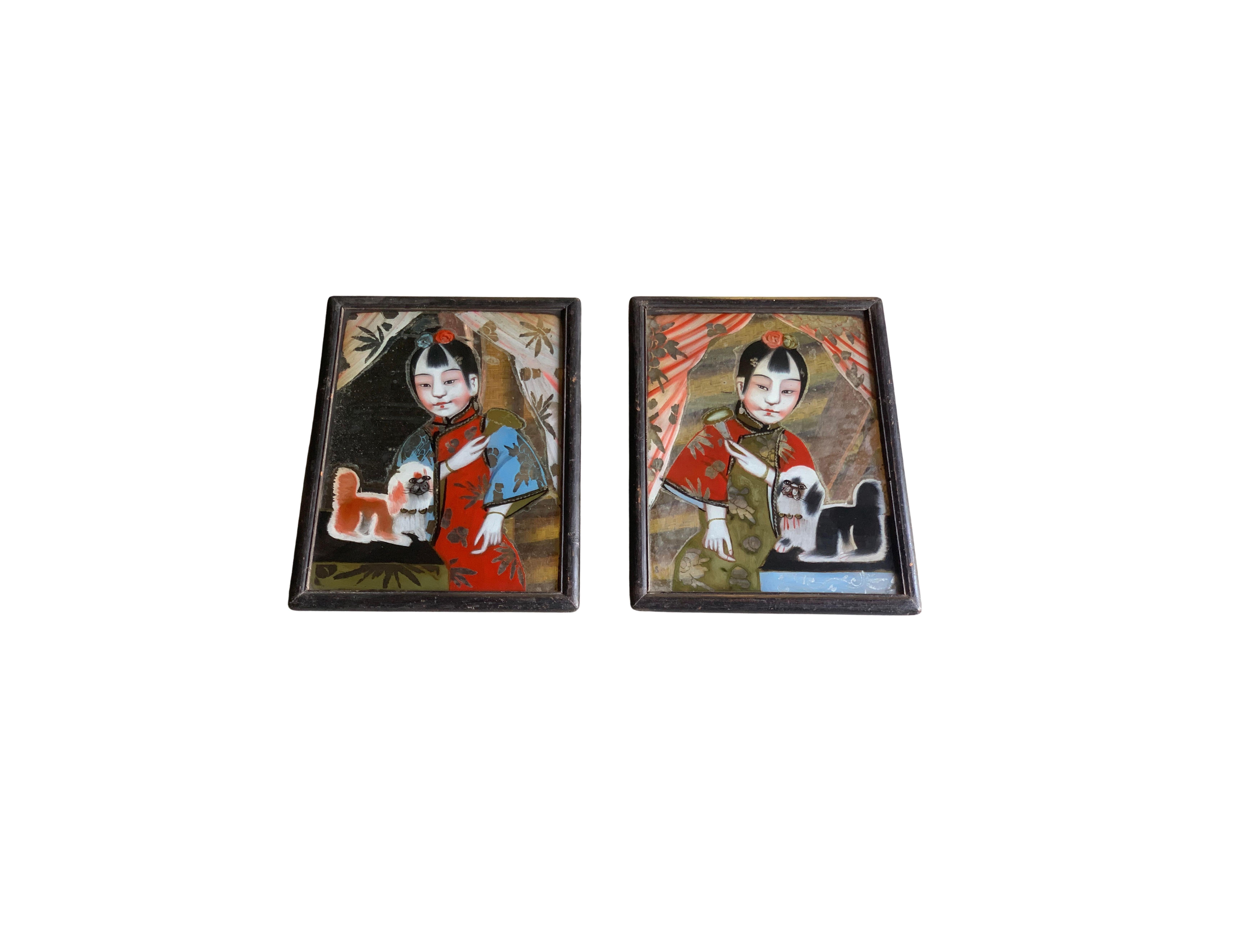 This pair of Chinese portraits depicting young women & their dogs were painted using a reverse glass painting technique. Painting in reverse on the opposite side of a piece of glass meant the painter had to work in reverse. Unique to this pair of