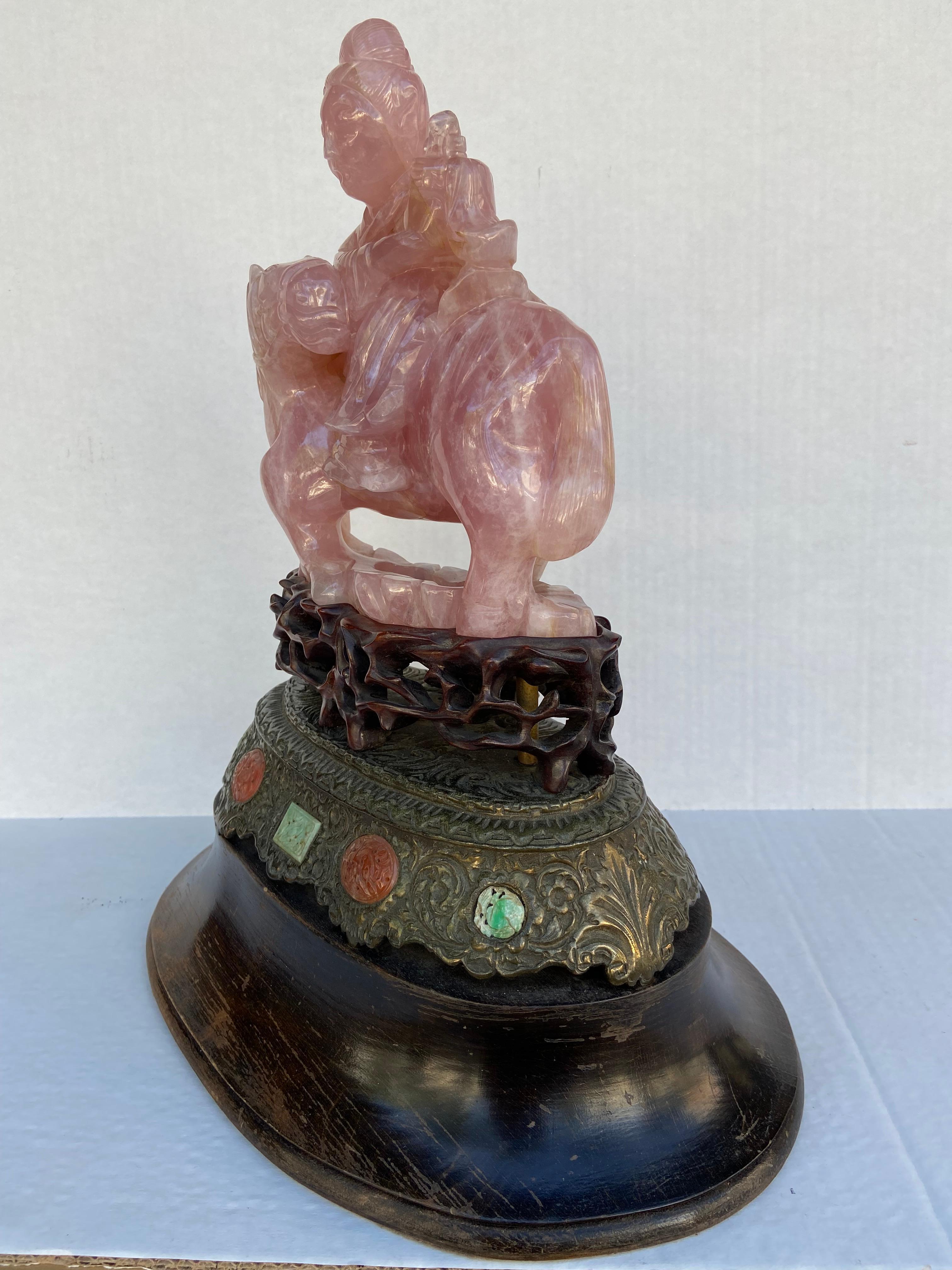 Pair of Chinese Rose Pink Quartz Equestrian Statues hand carved and crafted . Seated Guan Yin atop a horse with his head turned on to one side. A carved 