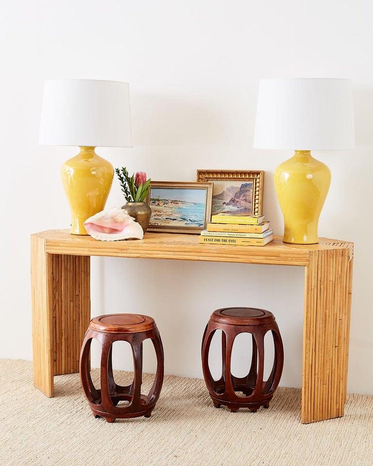 Handsome pair of Chinese carved rosewood barrel drum stools or drinks tables. Featuring oval shaped windows made in a ming style. The drum form stools showcase the beautifully grained hardwood with a rich finish.