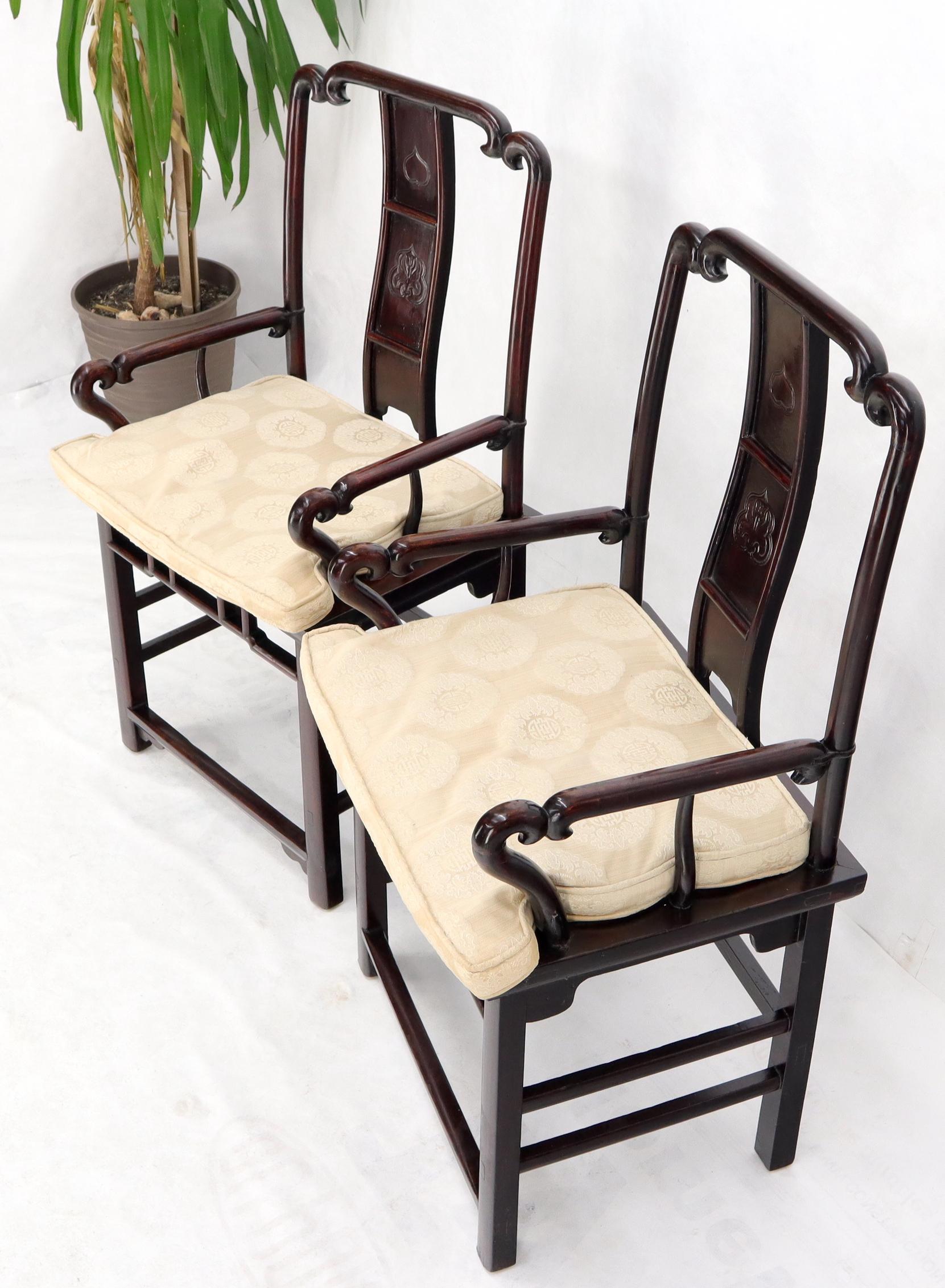 Pair of decorative Chinese Asian arm dining chairs.