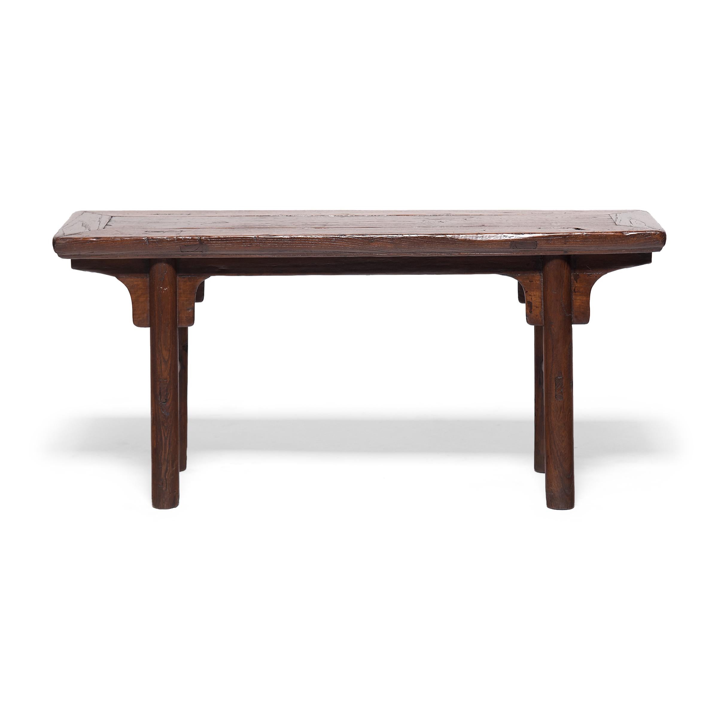 These early 20th century elmwood benches would have originally resided in the courtyard of a Qing-dynasty home to provide much-needed outdoor seating on hot summer days. The benches are designed in a classical Ming style, with a floating panel top,