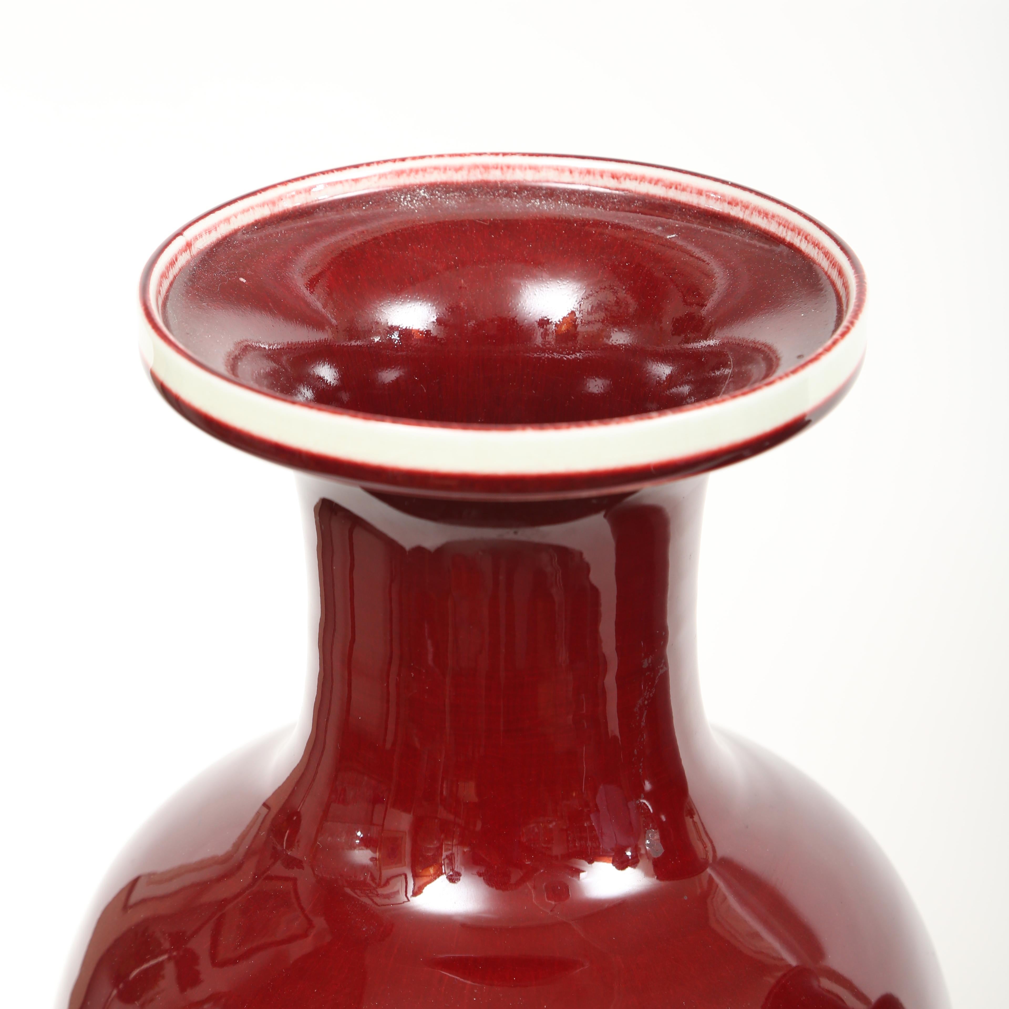 Large pair of Chinese sang de boeuf or oxblood vases. The oxblood glaze is magnificent for there is such depth and richness of color. These are hand thrown and do show some slight differences that you would expect to find in artisan made ceramics.