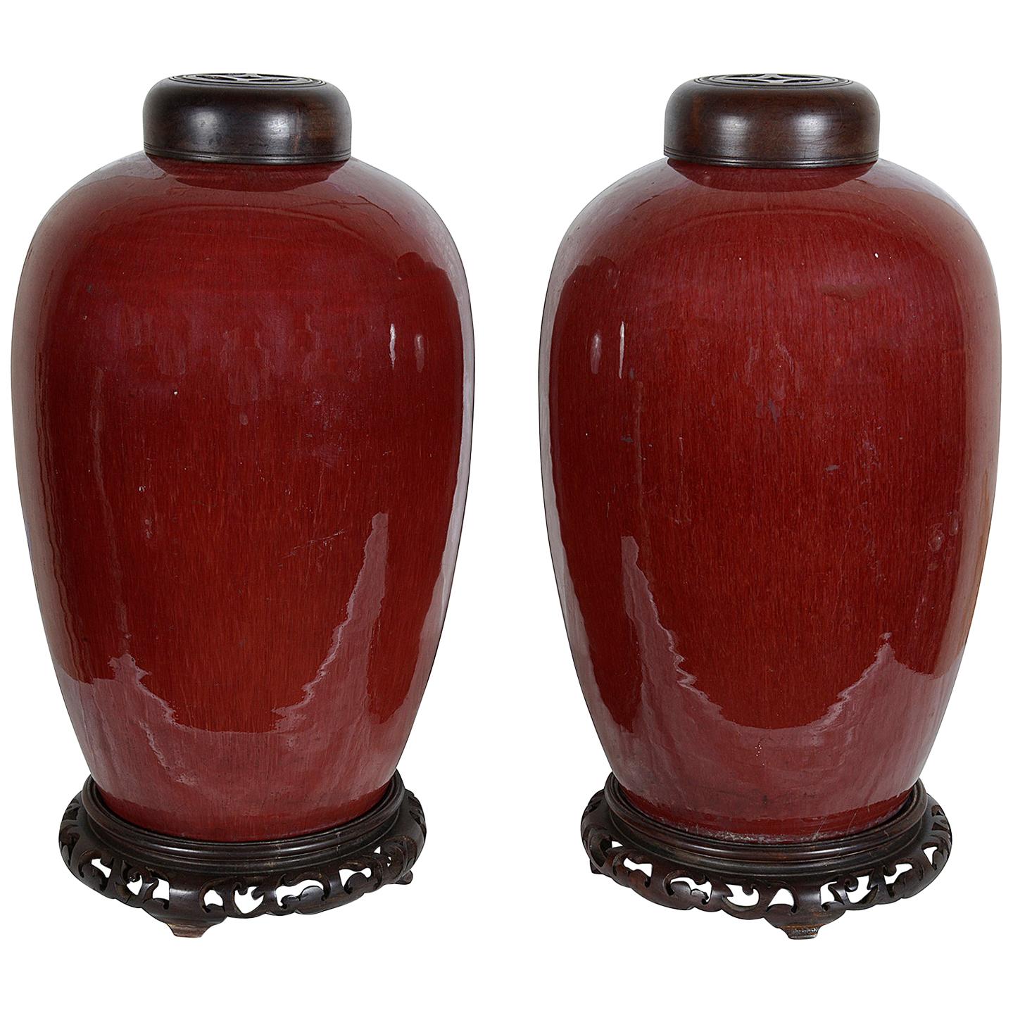 Pair of Chinese Sang Du Bouf lidded vases, circa 1890