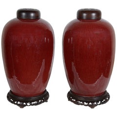 Pair of Chinese Sang Du Bouf lidded vases, circa 1890