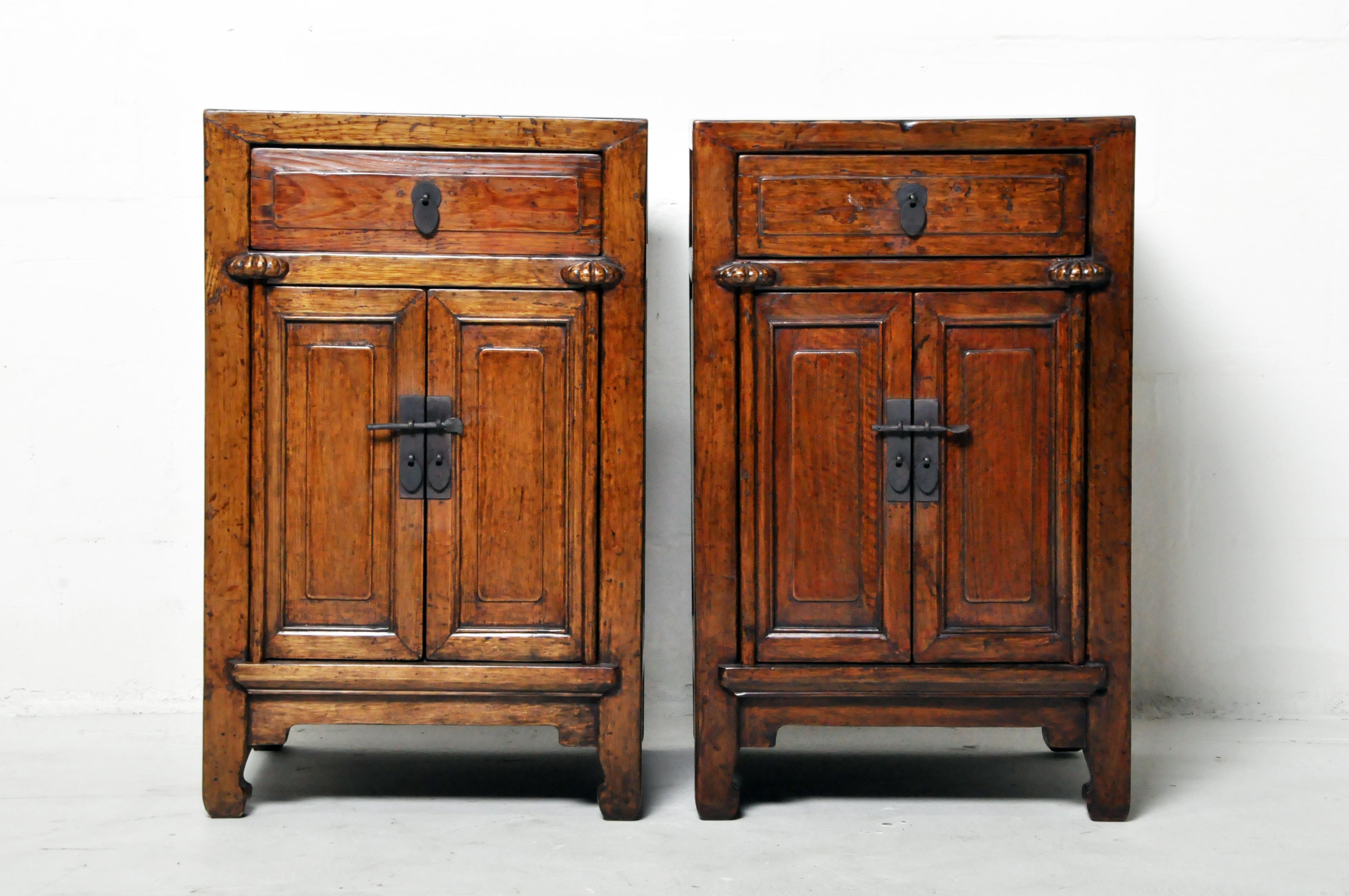 A restored pair of Chinese side chests. These chests are made from elmwood and were once covered in natural lacquer. That original lacquer (some oxblood remains) was gently removed and the wood grain was revealed and protected by a modern layer of